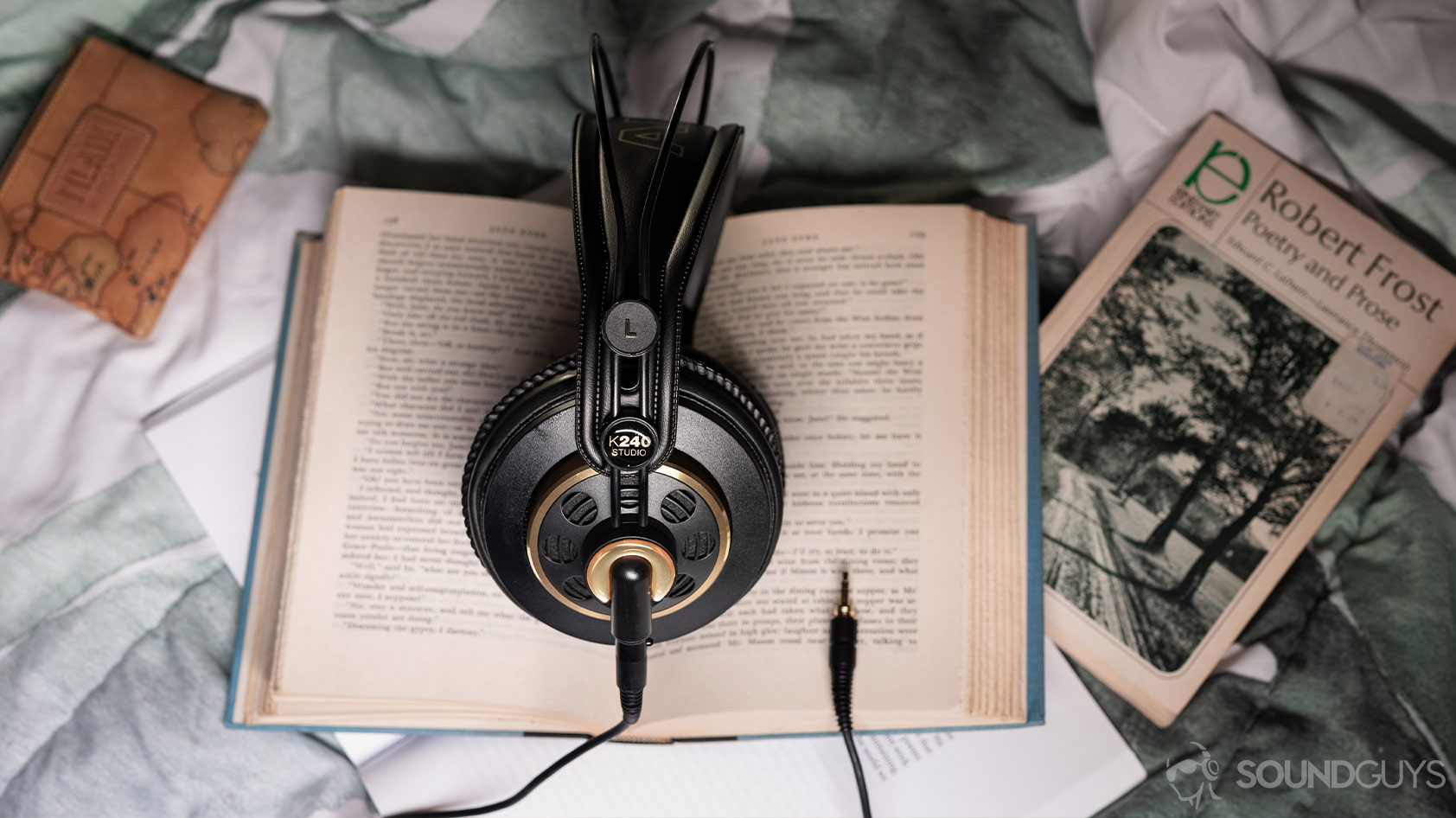 AKG K240-open headphones books An aerial photo of the AKG K240 Studio semi-open headphones on an open book.