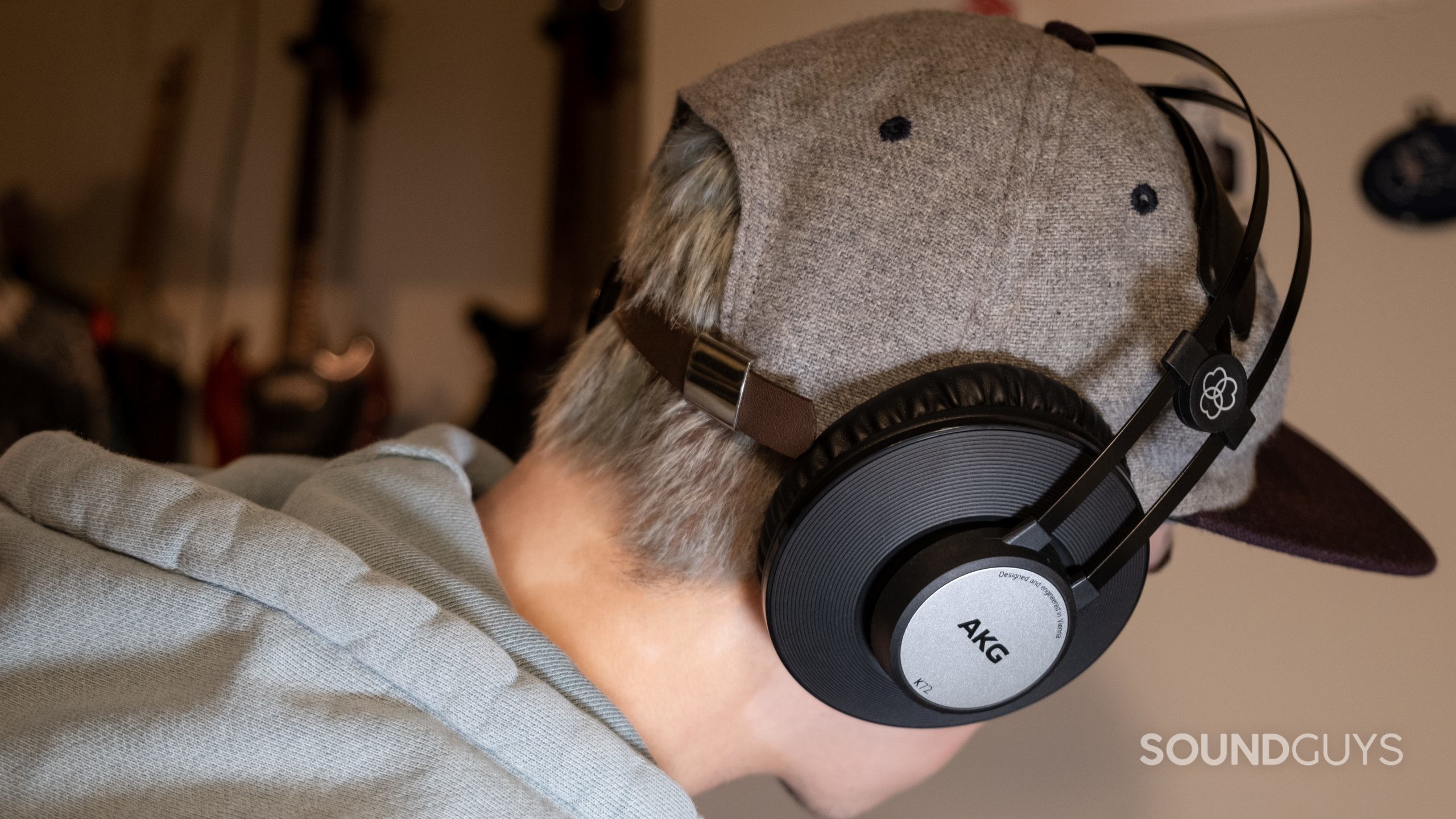 akg-k72-on-ears The AKG K72 as worn on a person facing away from the camera wearing a hat.