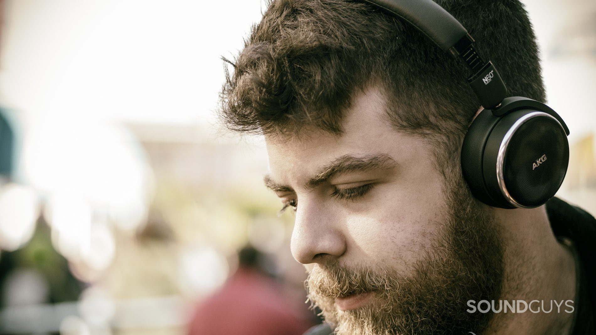akg-n-60-nc-review-wear-4 A man wears the AKG N60NC on-ear noise canceling headphones outside.