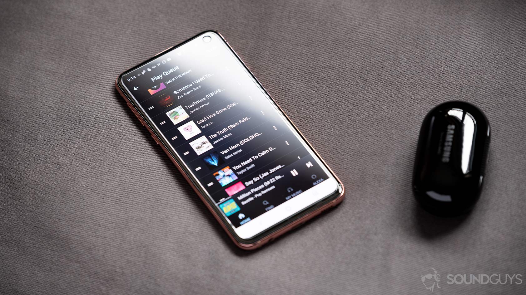 Amazon Music HD-mobile app queue samsung galaxy buds plus A picture of the Amazon Music HD mobile app play queue page next to a Samsung Galaxy Plus case.