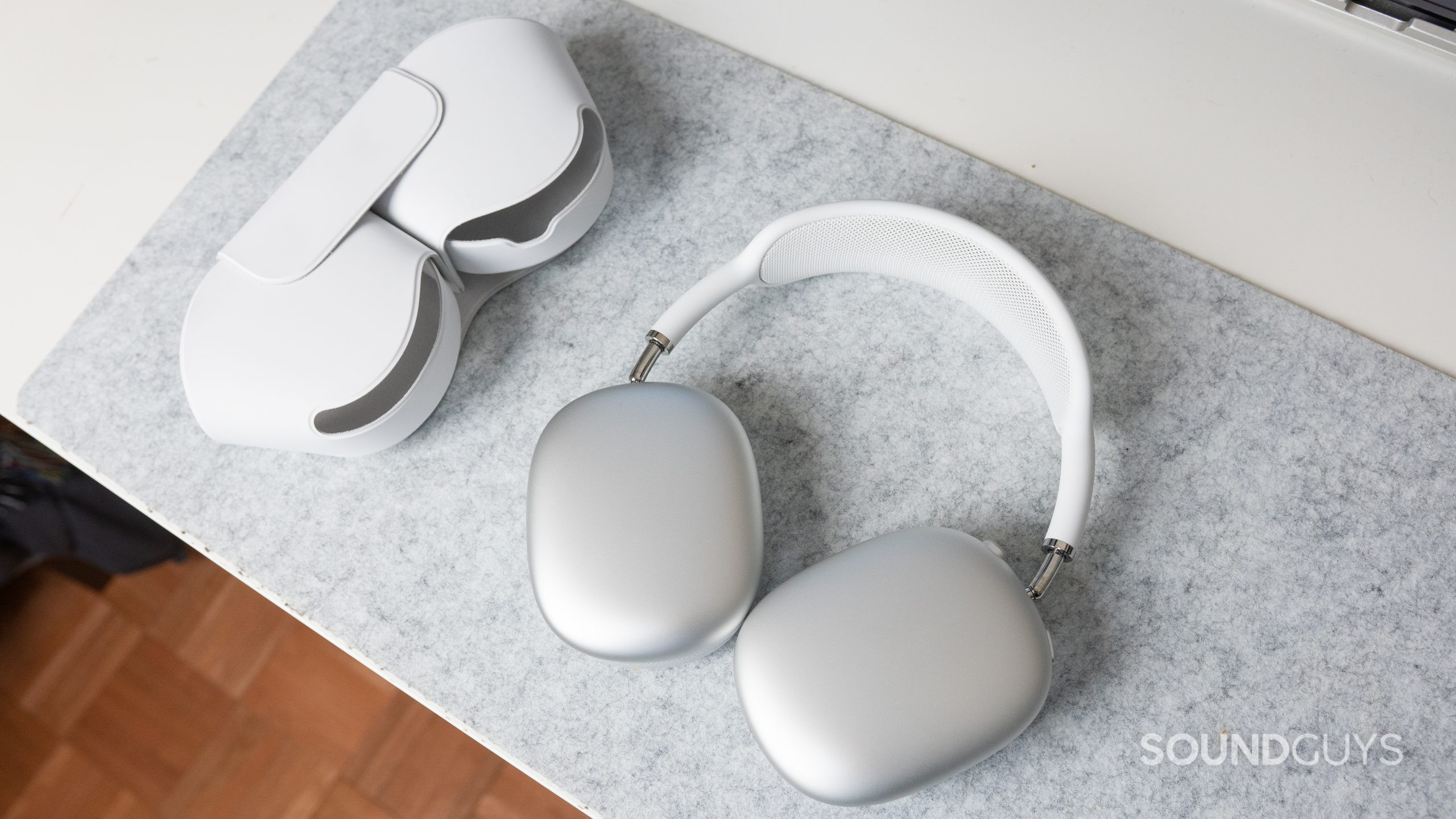 Apple AirPods Max smart case. The Apple AirPods Max and its smart case on a white desk.