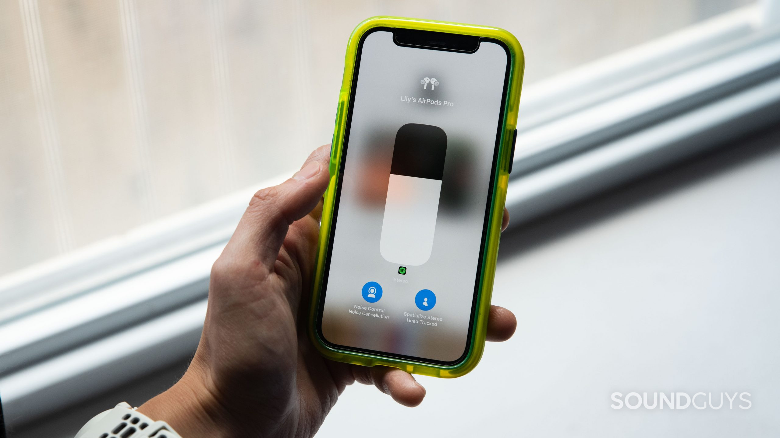 Apple AirPods Pro (2nd generation) true wireless earbuds listening modes noise canceling spatial audio A hand holds an iPhone 12 mini with the AirPods Pro 2nd generation sound mode settings pulled up.