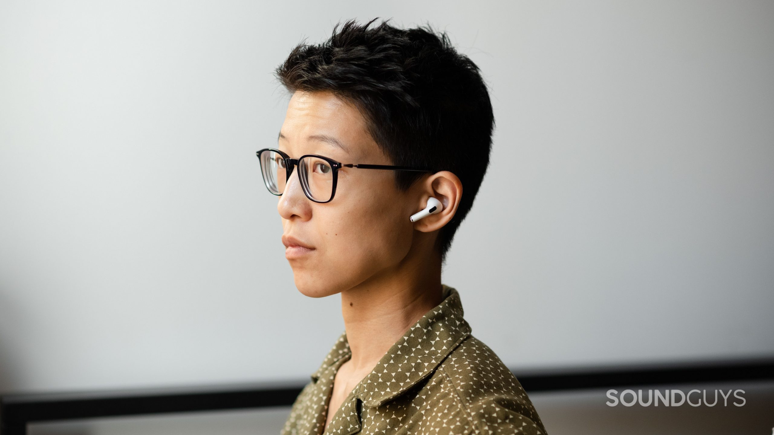 Apple AirPods Pro (2nd generation) true wireless earbuds person wears- (1) A person wears the Apple AirPods Pro (2nd generation) in three-quarters view.