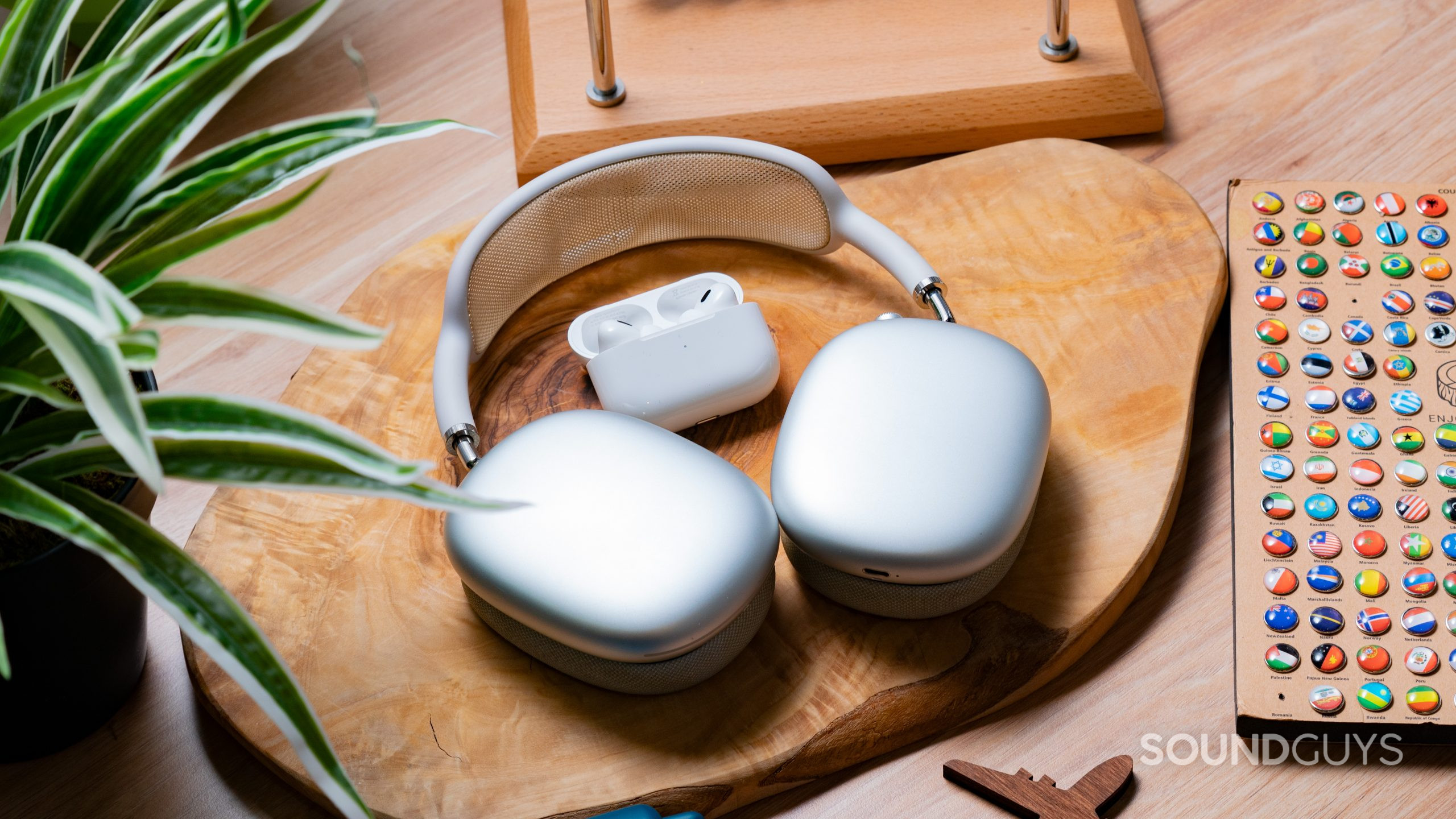 Apple Airpods Pro Gen 2 vs. Apple Airpods Pro Max Case Comparison The Apple AirPods Max and Apple AirPods Pro (2nd generation) on a wooden slab next to each other.