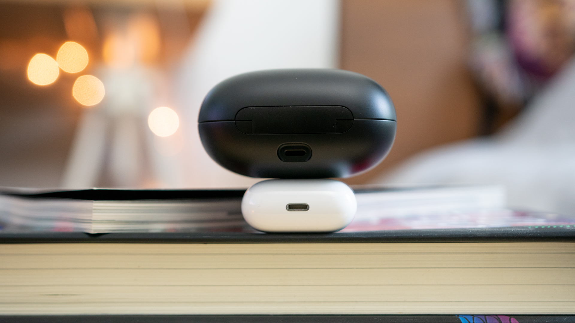 Apple Airpods Vs Powerbeats Pro-2 Close-up shot of the Lightning charging ports of both the Apple Airpods and the Powerbeats Pro
