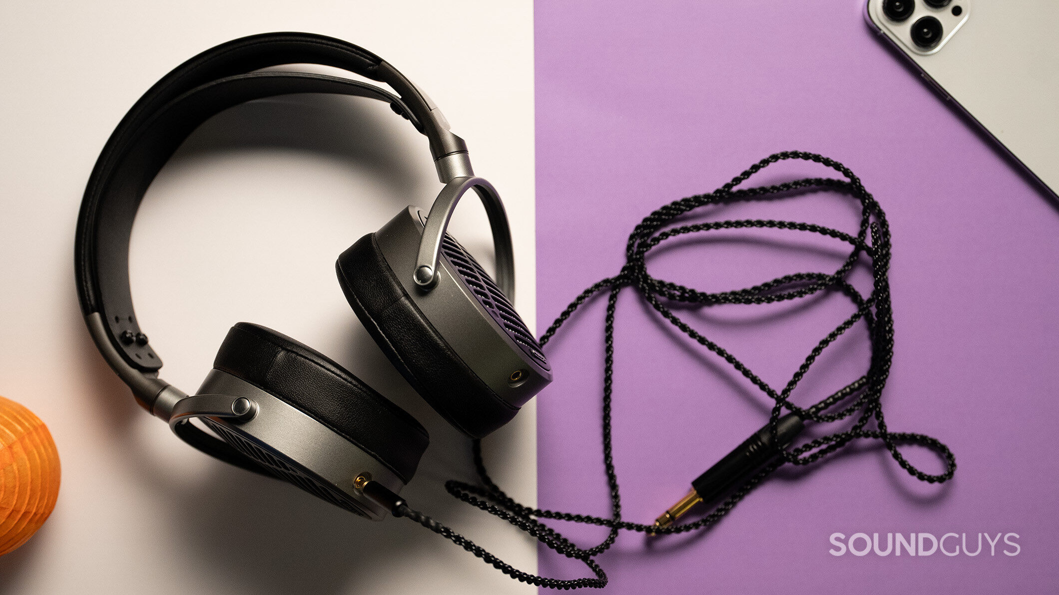 Audeze MM-100 accessories 2 Audeze MM-100 headphones on a white and purple table.