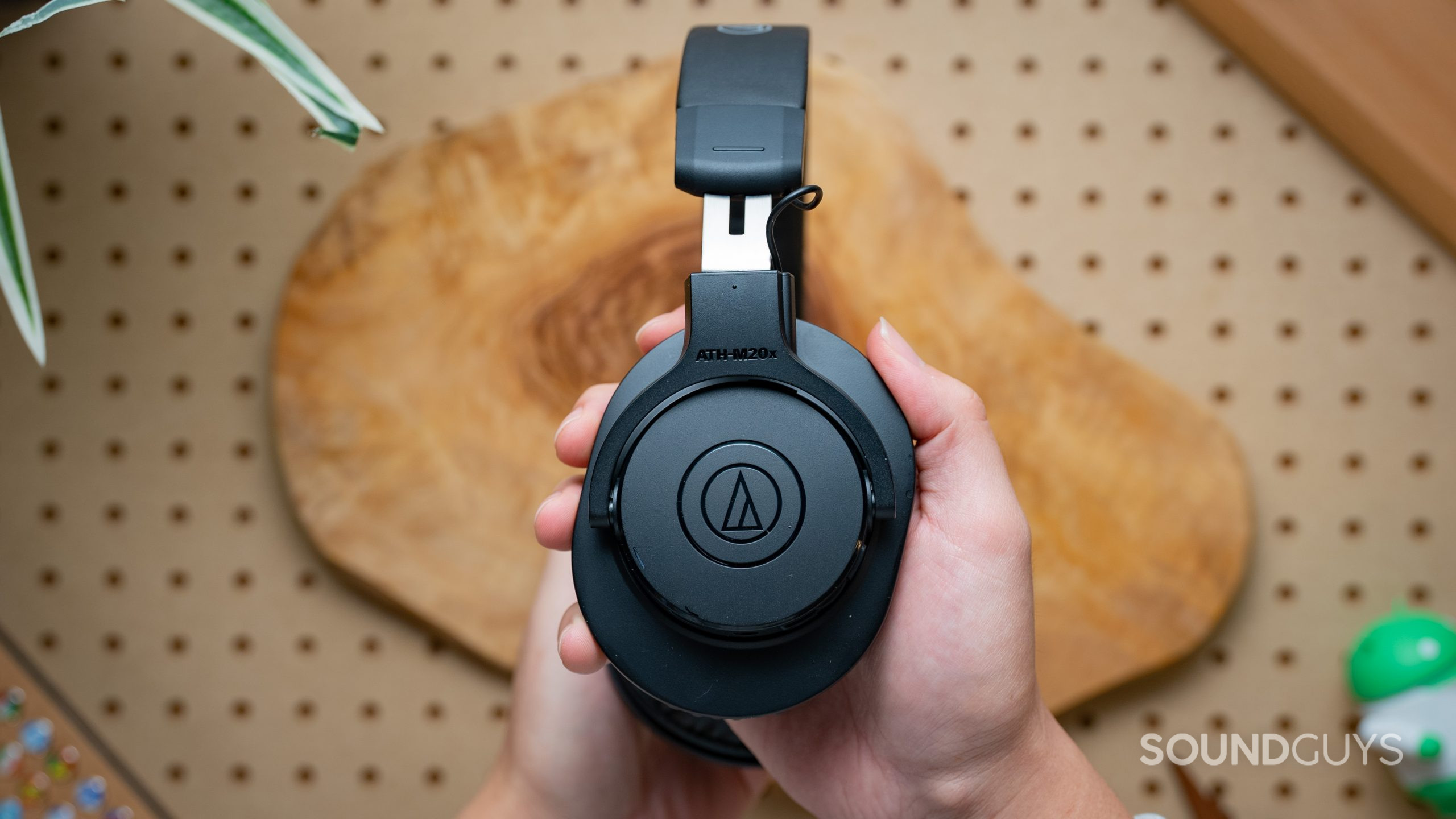 Audio-Technica ATH-M20xBT Headset Closed Back Image #1 A hand holds the Audio-Technica ATH-M20xBT shown from the side.