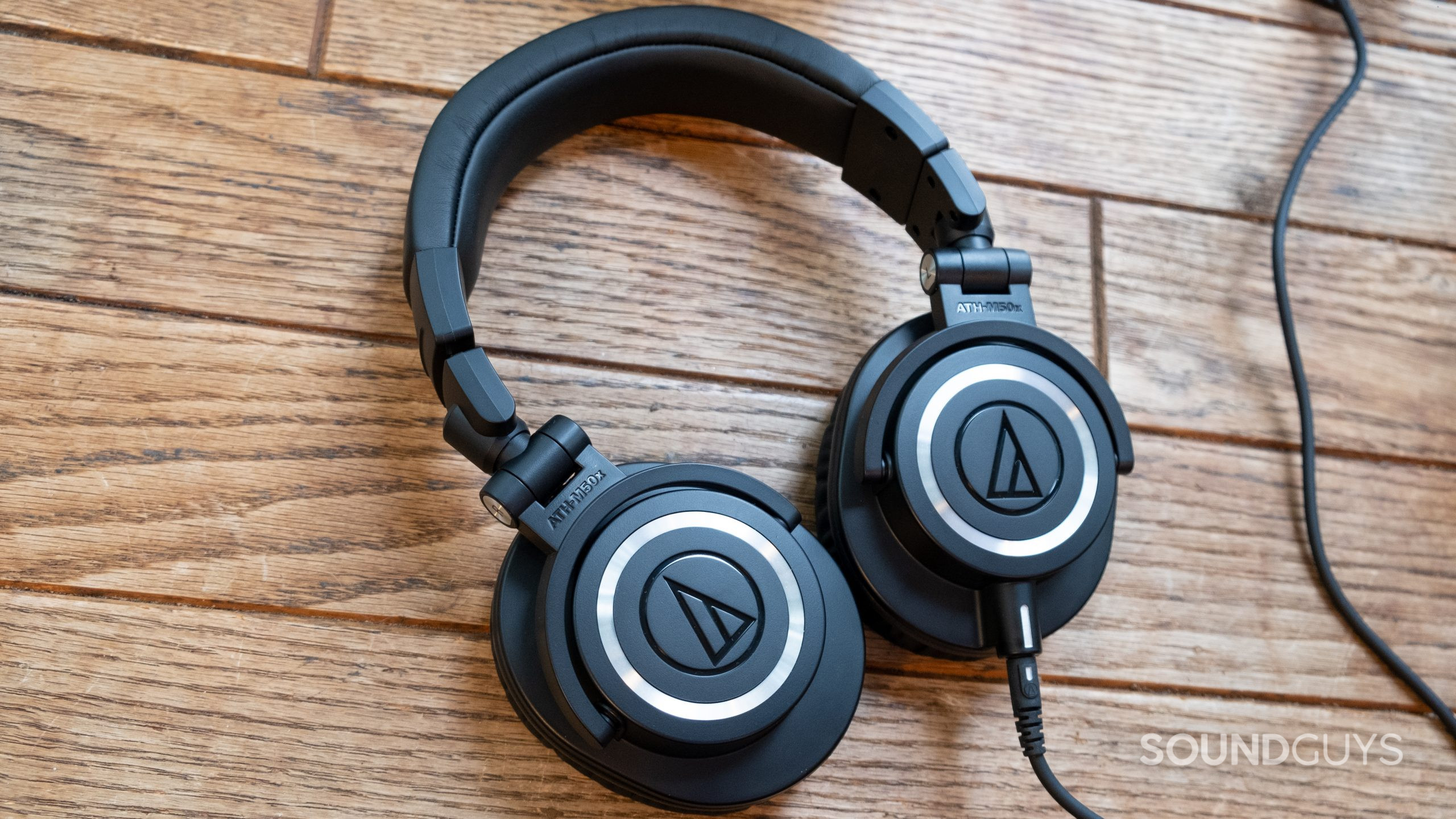 audio-technica-ath-m50x-center The Audio-Technica ATH-M50x laid flat on a wood surface.