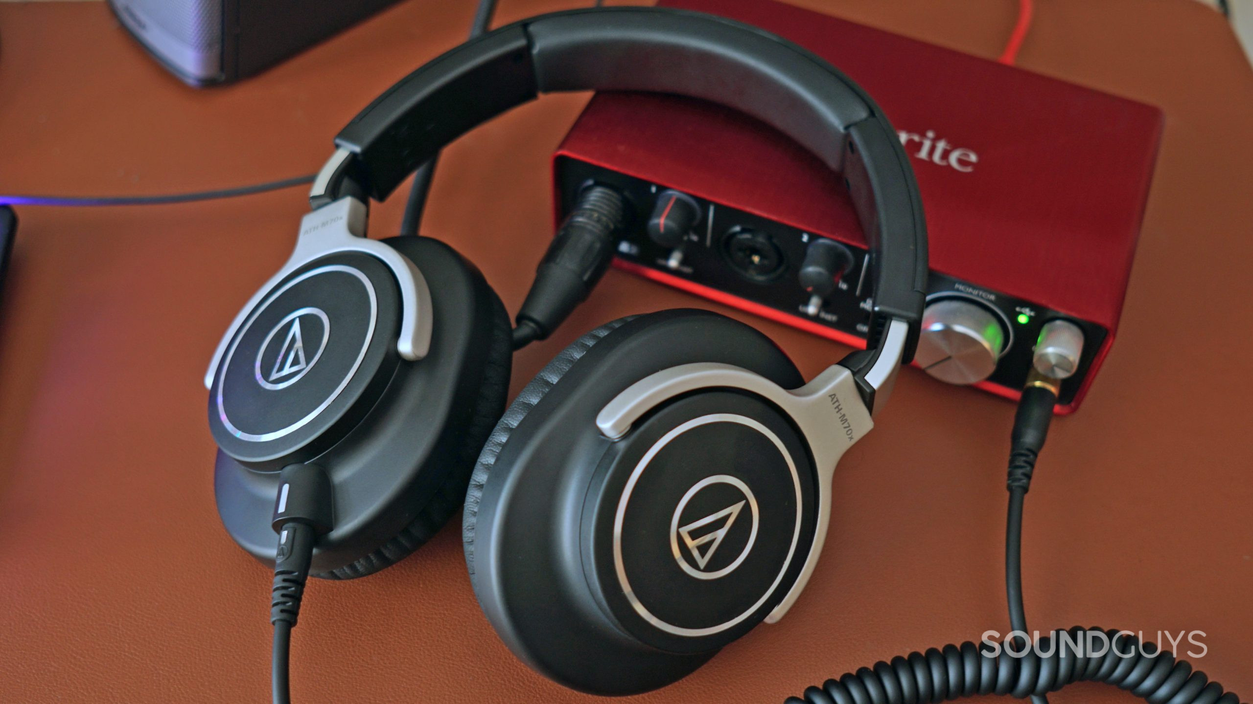 Audio-Technica-ATH-M70x-Scarlet-2 The Audio-Technica ATH-M70x lays on a Focusrite Scarlett 2i2 which it's plugged into.