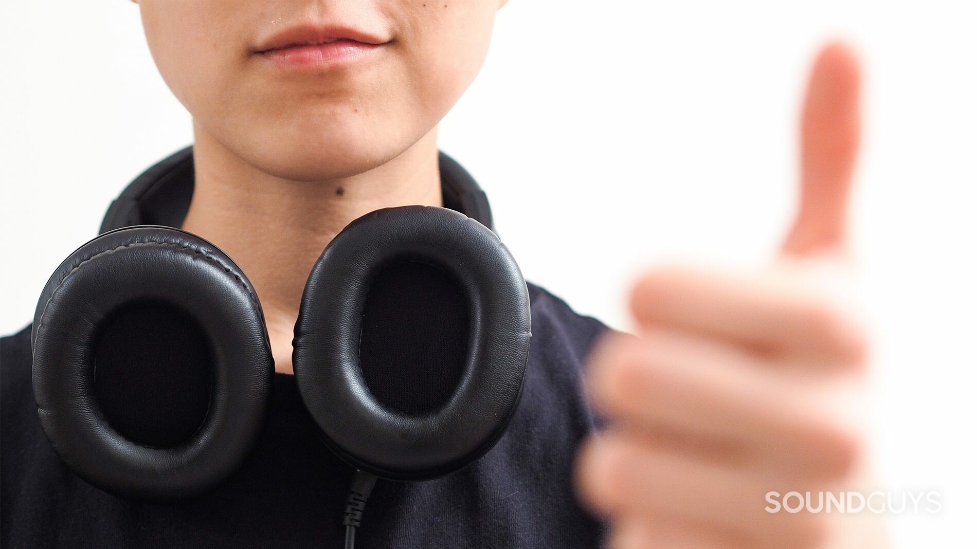 Audio-Technica_ATH-M40x_2_LK_SG A photo of Lily Katz wearing Audio-Technica headphones, giving the thumbs-up.