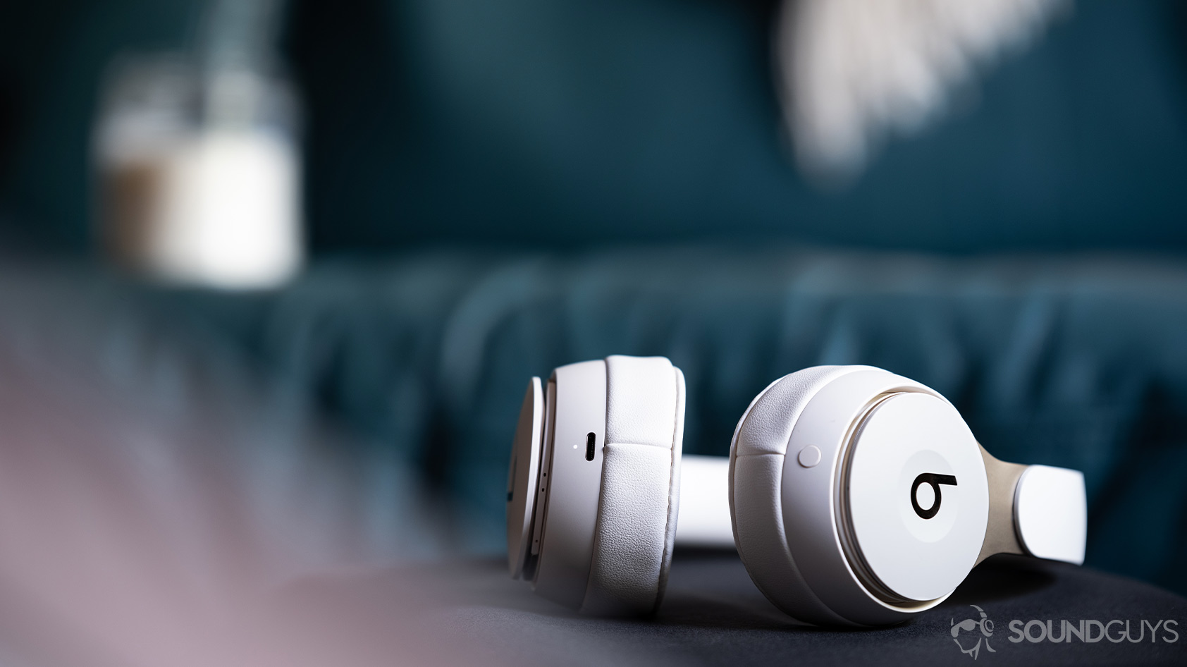 Beats Solo Pro-noise canceling headphones Lightning connector input Apple A photo of the Beats Solo Pro on-ear noise canceling headphones lying on a black surface with the Lightning input in focus.