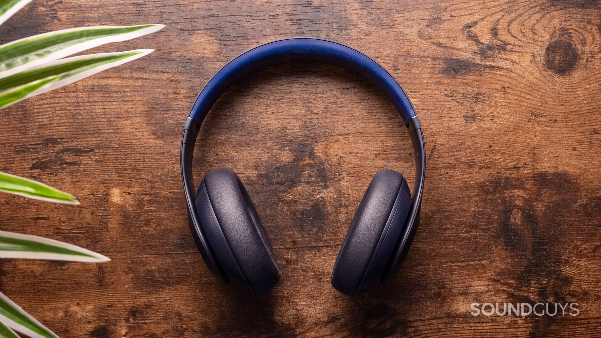 beats-studio-pro-reverse The Beats Studio Pro lay flat on a wooden surface.