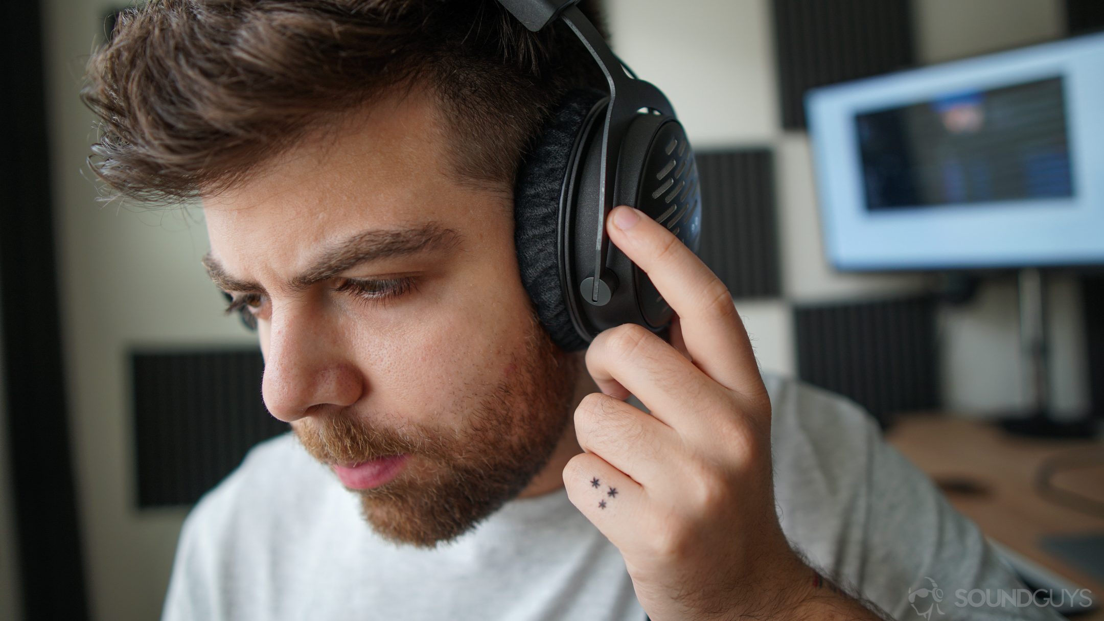 Beyerdynamic DT 1990 Pro-6 A photo of a man listening to the Beyerdynamic DT 1990 Pro, with high-def equipment, including a DAC