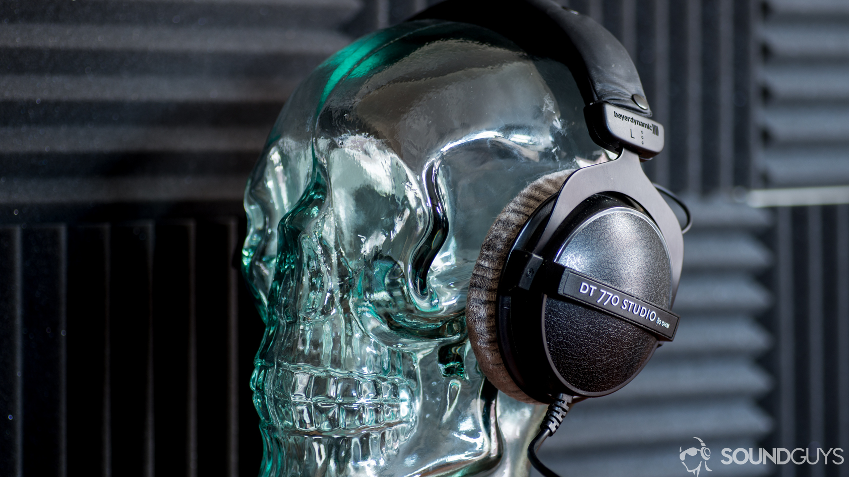 beyerdynamic-dt-770-studio-80-ohm-wear A photo of the Beyerdynamic DT 770 Studio 80 ohm sitting on a glass skull display.