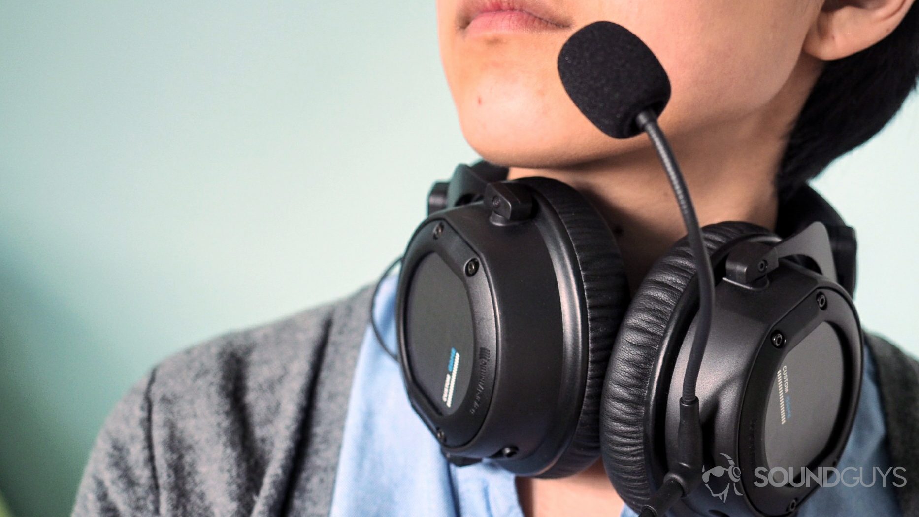 Beyerdynamic_Custom Game_feech Beyerdynamic Custom Game headset being worn around the neck with the mic to the mouth.