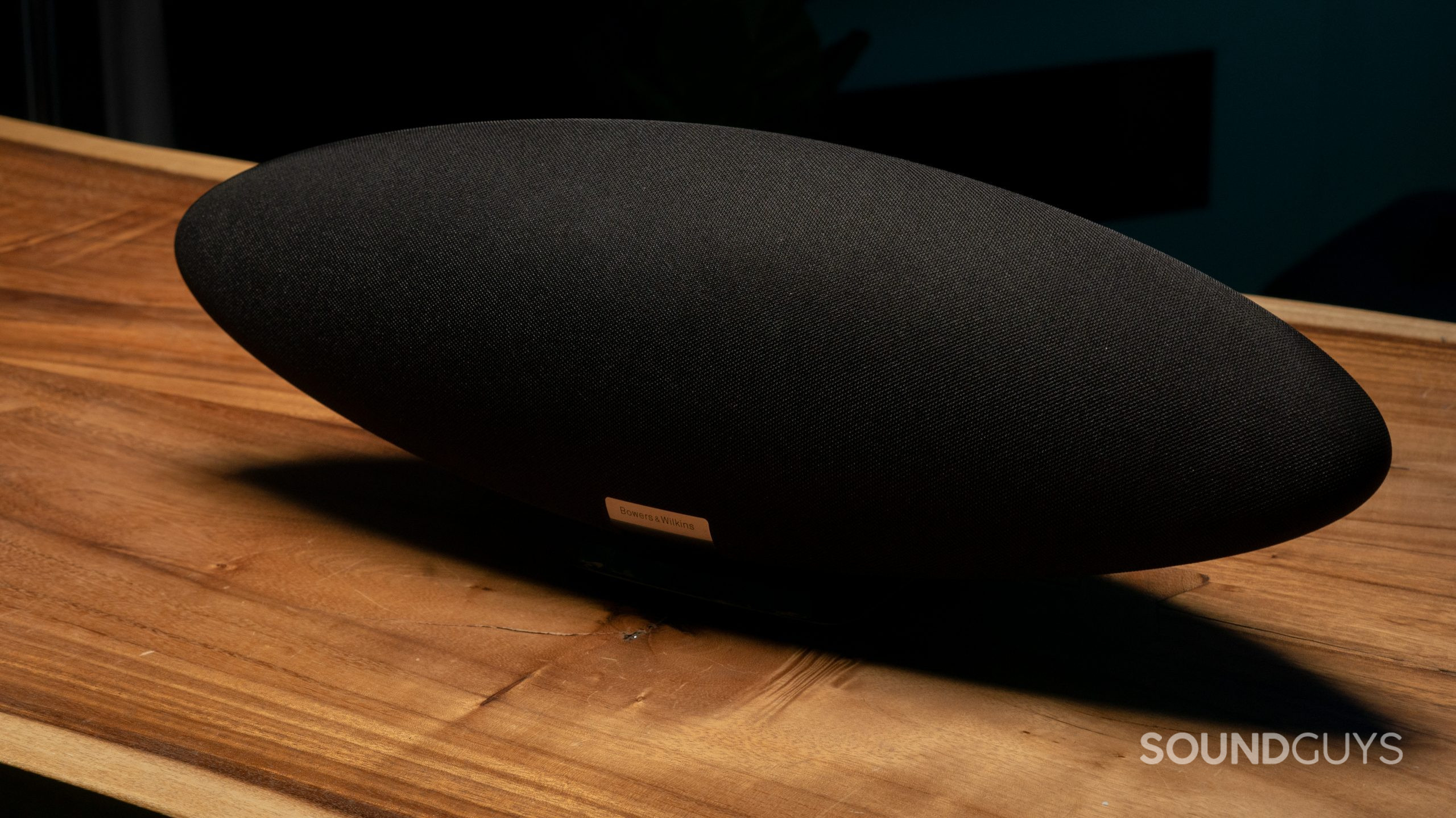 bowers-wilkins-zeppelin-3 A black Bowers & Wilkins Zeppelin speaker shown at an angle fron the front on a wooden table.