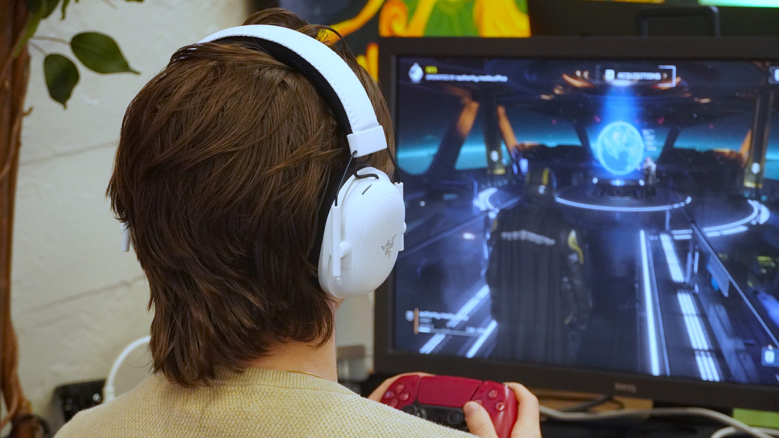 chase gaming A man wearing the Razer BlackShark V2 Pro while gaming