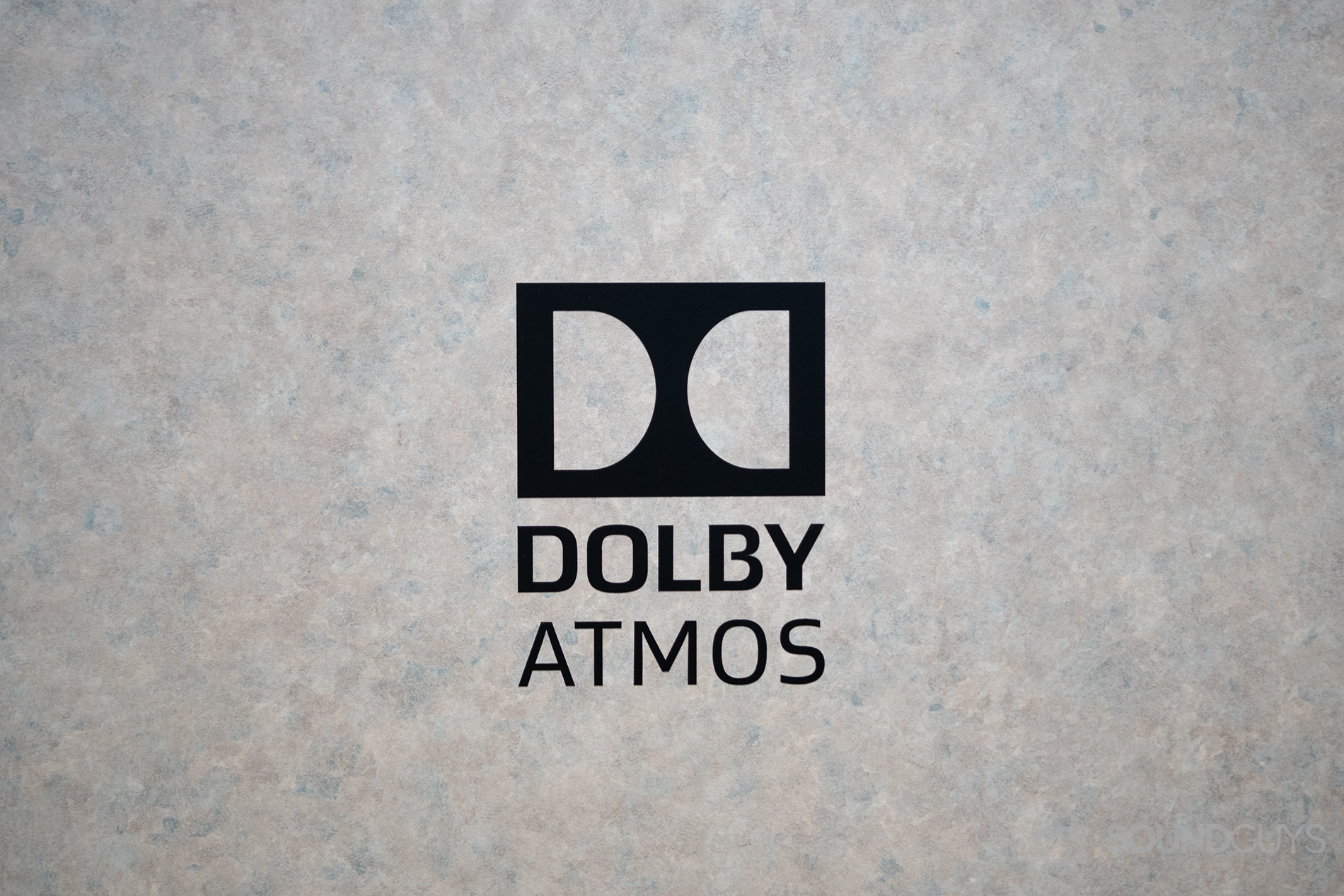 Dolby Atmos-logo A black Dolby Atmos logo atop a marble backdrop.