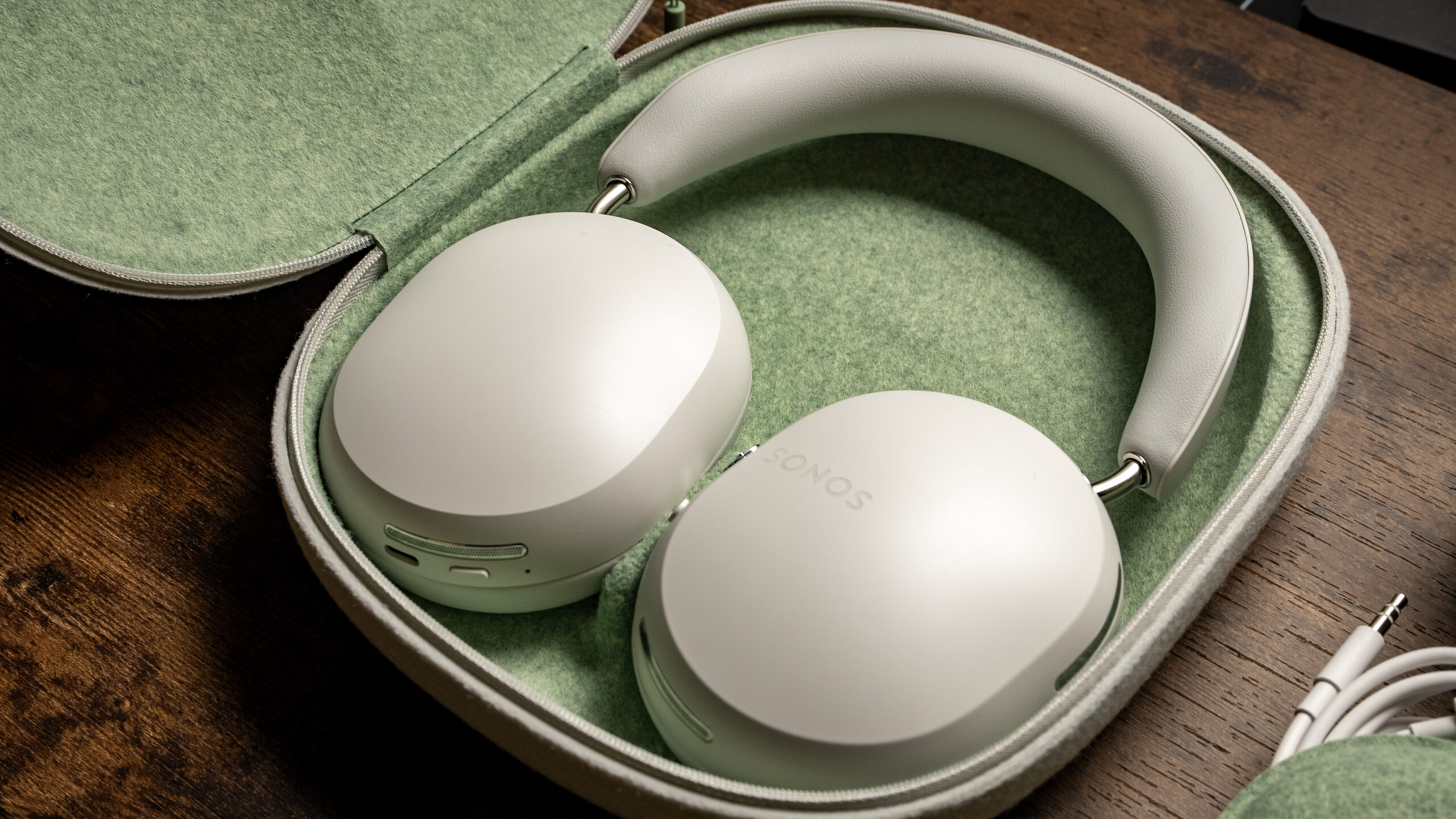 Sonos Ace headphones in carrying case A picture of the Sonos Ace headphones placed inside of its mint green-interior carrying case