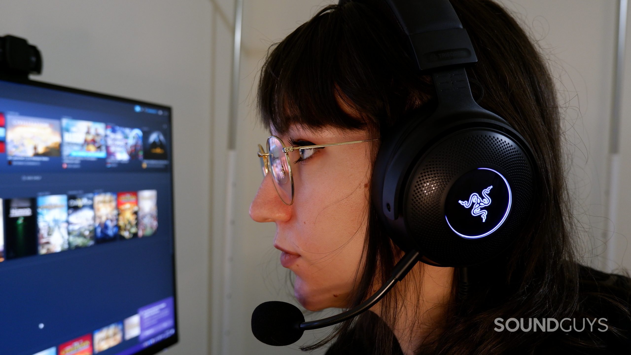 razer-kraken-v3-gaming-head A person wearing a Razer Kraken V3 headset, looking at a computer stream with Steam open.