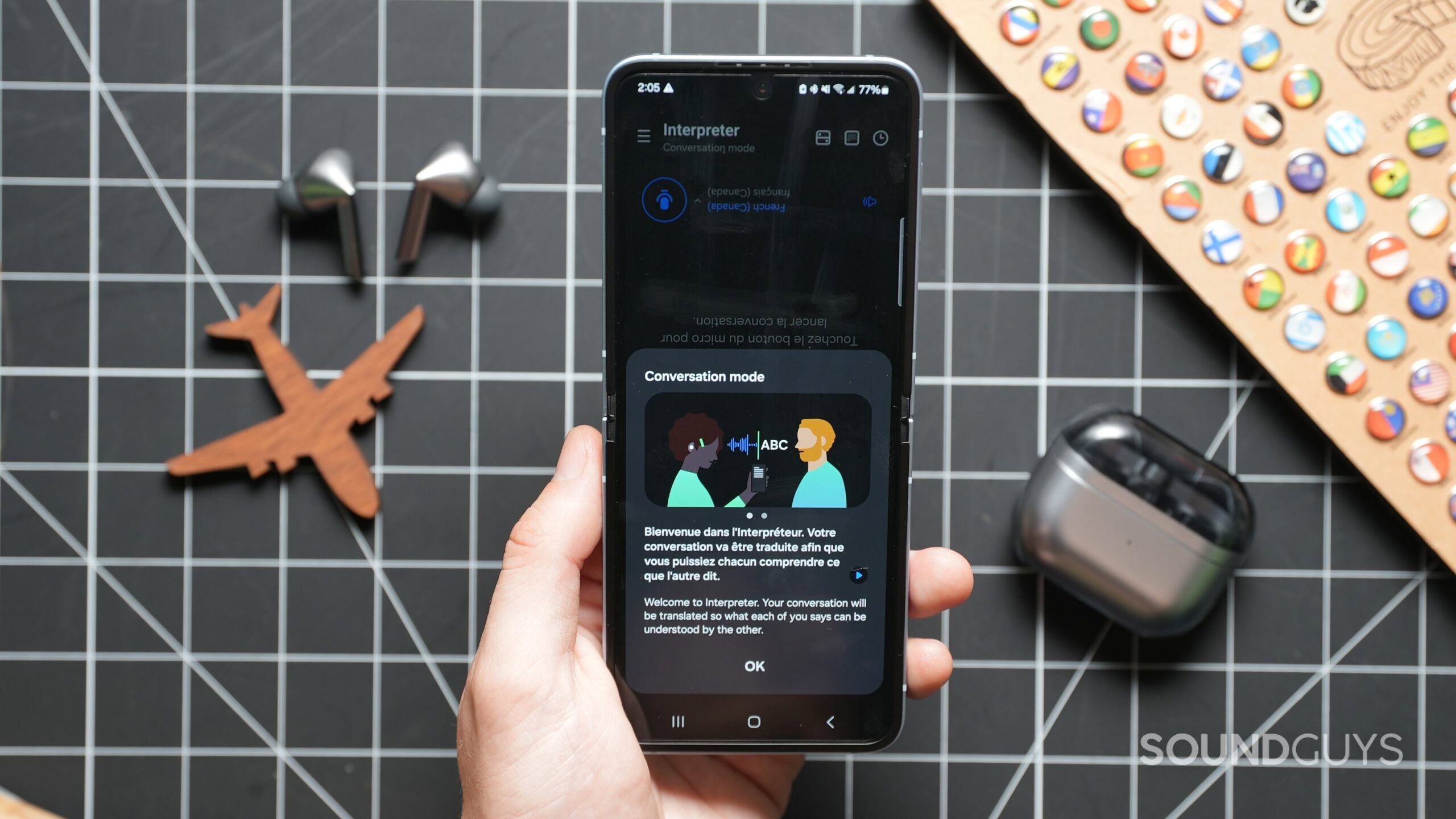 Galaxy AI Interpreter Conversation A hand holding the Samsung Galaxy Flip 6 with Galaxy AI Interpreter on screen
