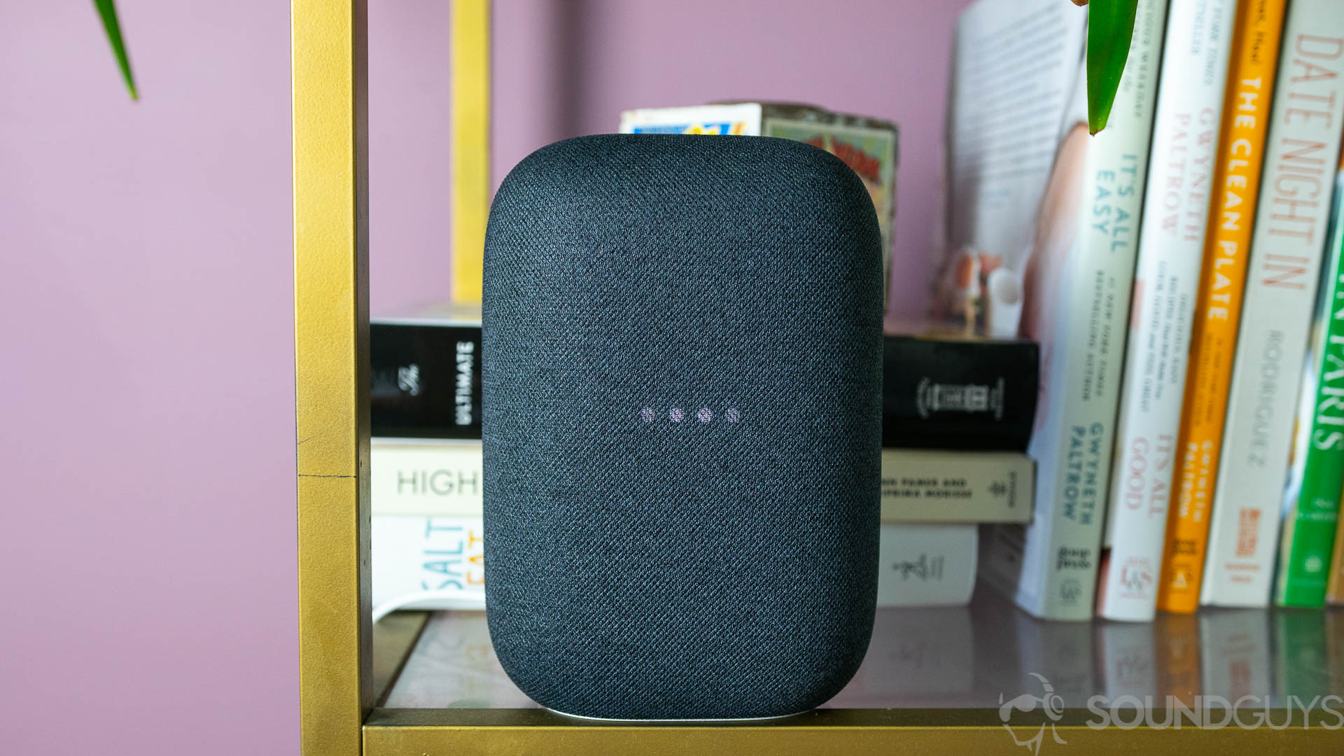 Google Nest Audio hotword LED lights Pictured is the gray Google Nest Audio on a bookshelf with the lights blinking.