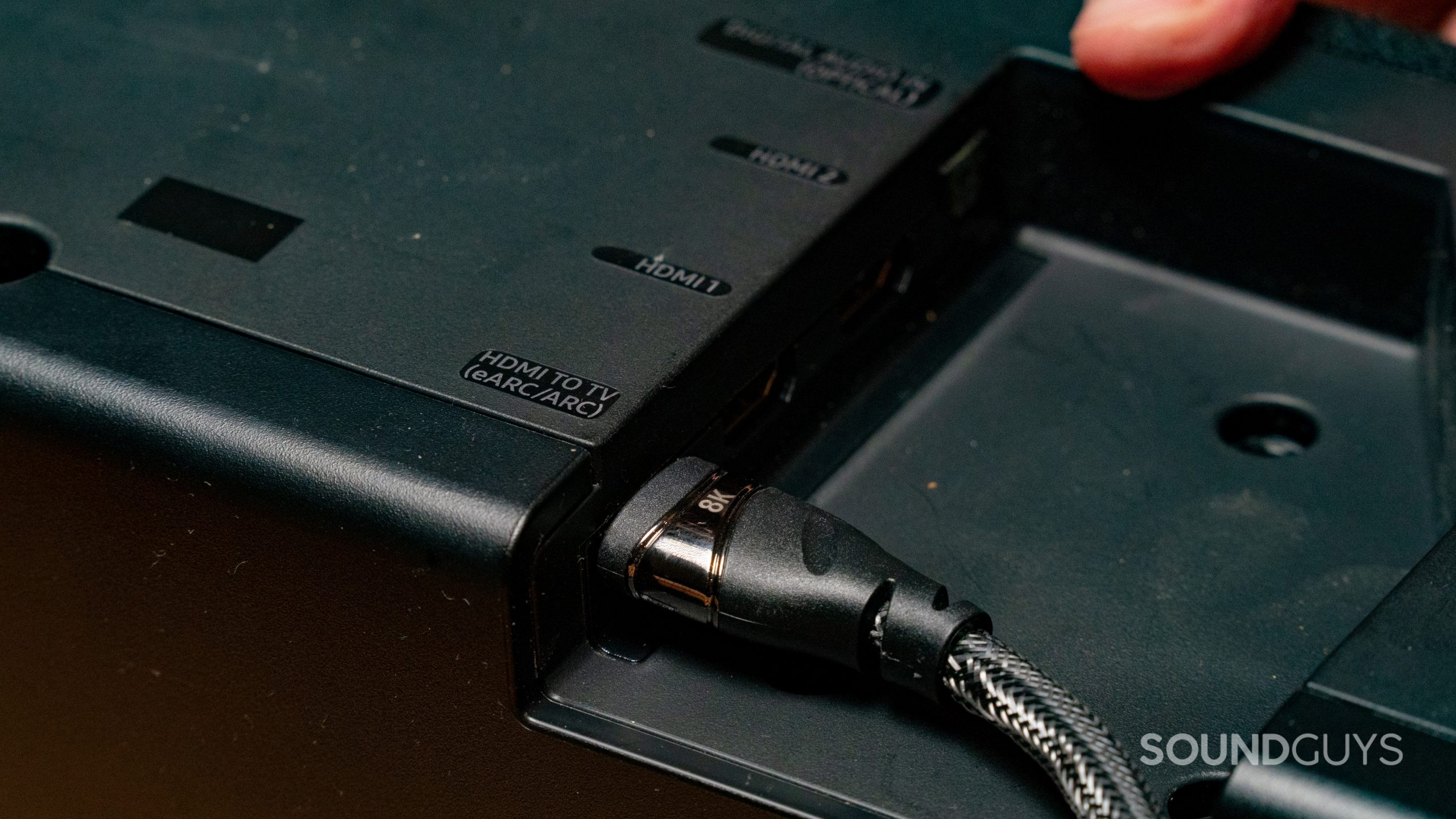 HDMI_5 HDMI sockets on the back of a soundbar, one of which is labelled HDMI eARC. A cable is plugged into one.