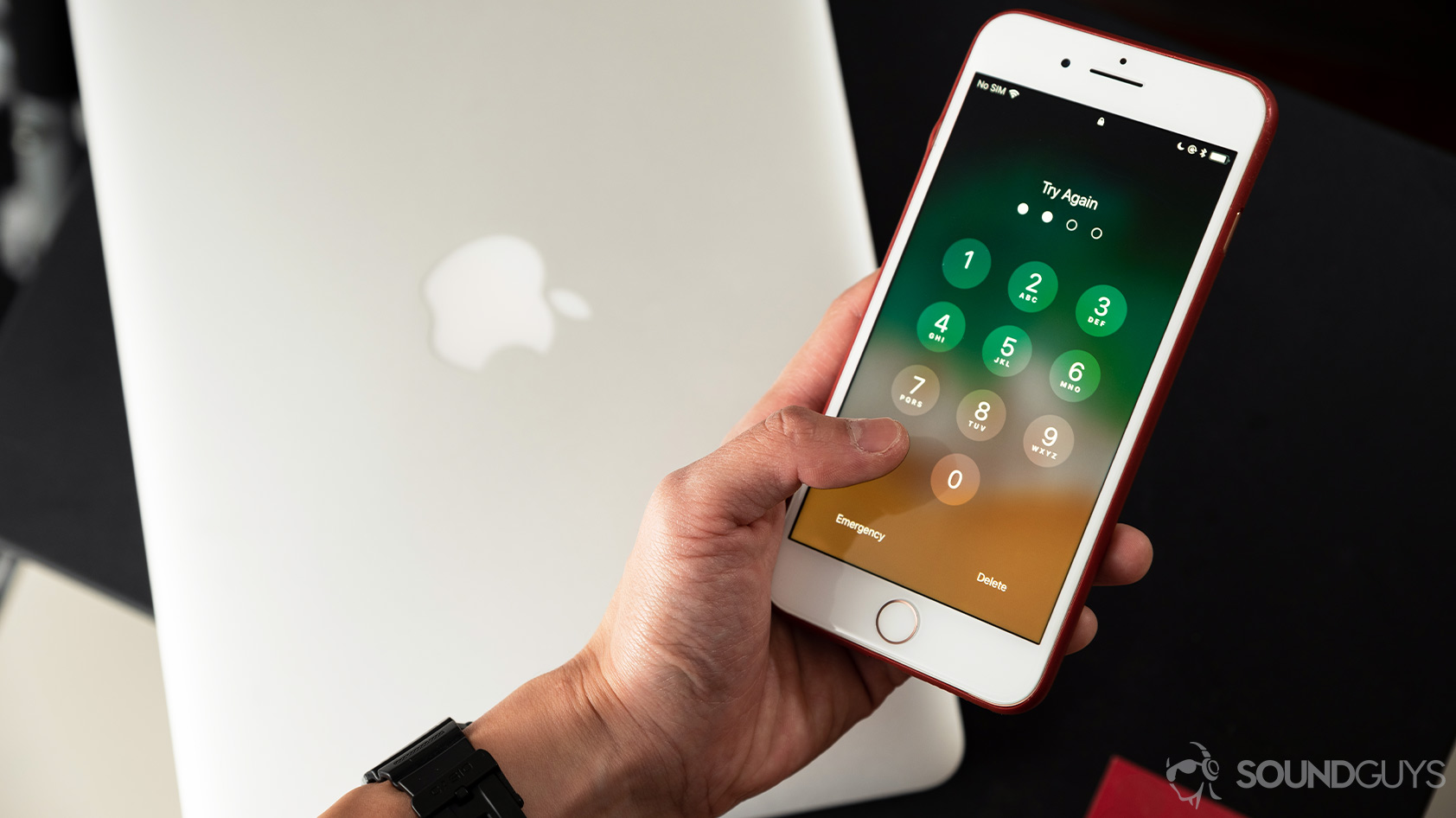 headphone data collection-Apple iPhone passcode A hand holds an iPhone 8 Plus with the passcode lockscreen on display.