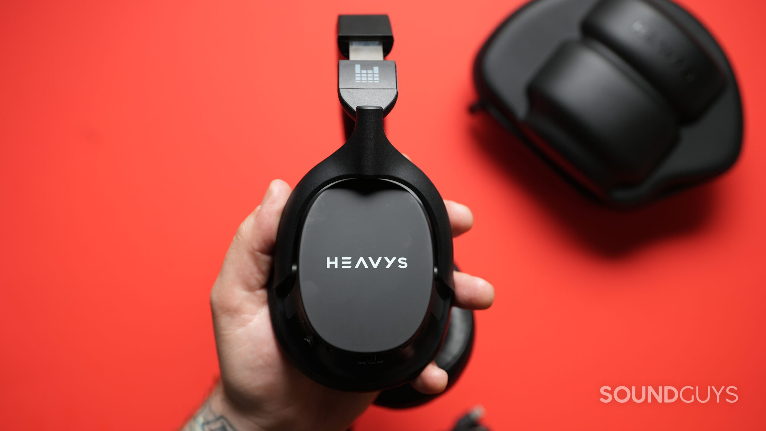 Heavys H1H shell and case Top down photo of the Heavy H1H headphones replaceable outer shell showing "Heavys" logo