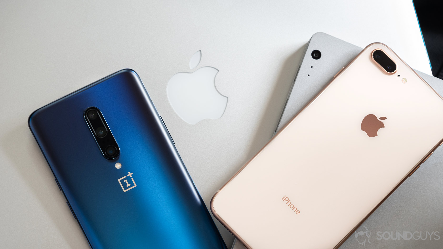 How to use Bluetooth OnePlus 7 Pro iPhone 7 Plus Macbook Pro Surface Book Pro-SG A OnePlus 7 Pro, iPhone 7 Plus, Macbook Pro, and Surface Book Pro all stacked on top of each other to demonstrate how to use Bluetooth across a range of devices.