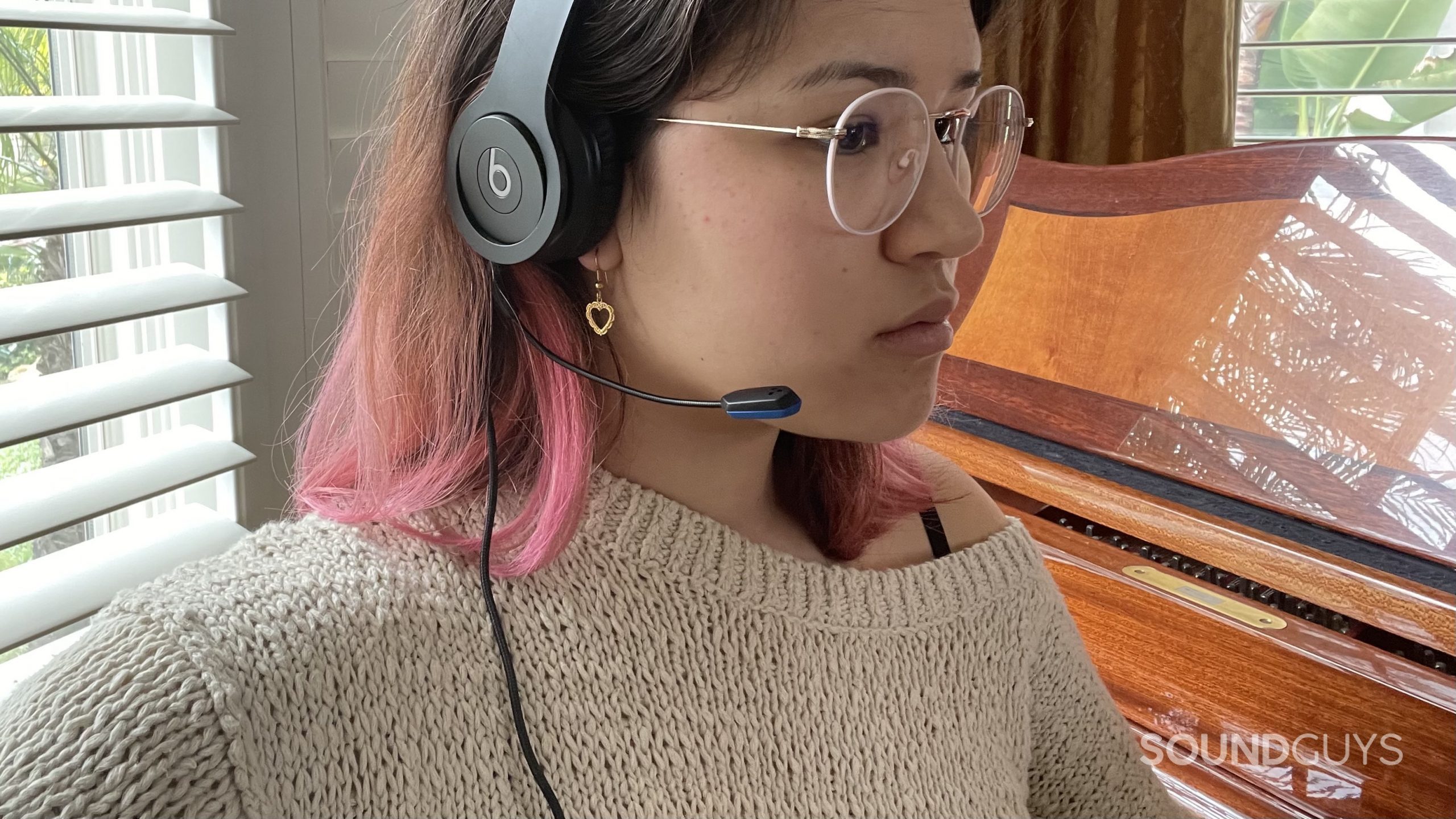 V-Moda BoomPro X woman wears beats headphones Woman wearing a pair of Beats headphones with the V-MODA BoomPro X plugged in.