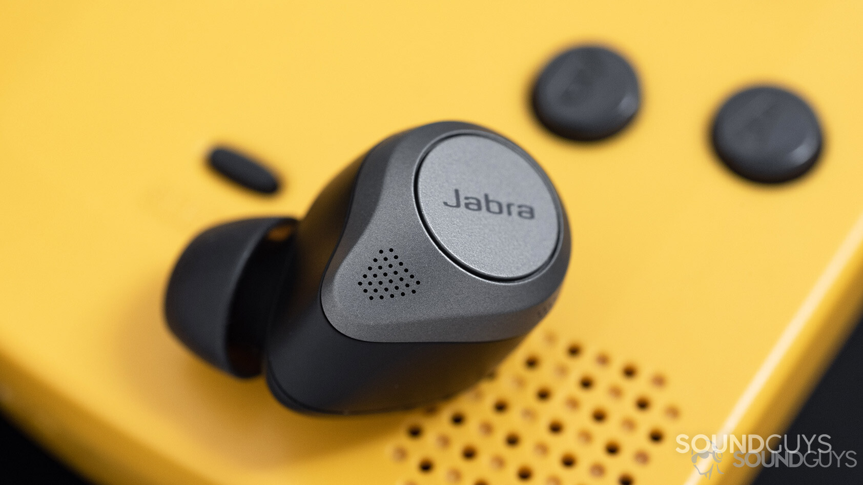 Jabra Elite 85t-noise canceling true wireless earbuds microphones The Jabra Elite 85t noise canceling true wireless earbuds microphone holes next to a Gameboy Color speaker grill.