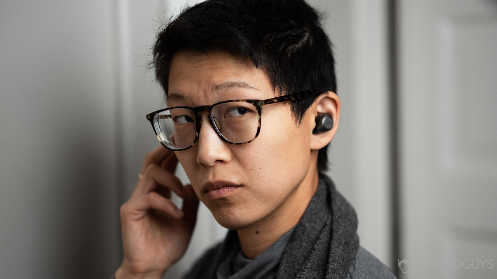 Jabra Elite 85t-noise canceling true wireless earbuds woman wears call controls A woman wears the Jabra Elite 85t and operates the right earbud's control button.