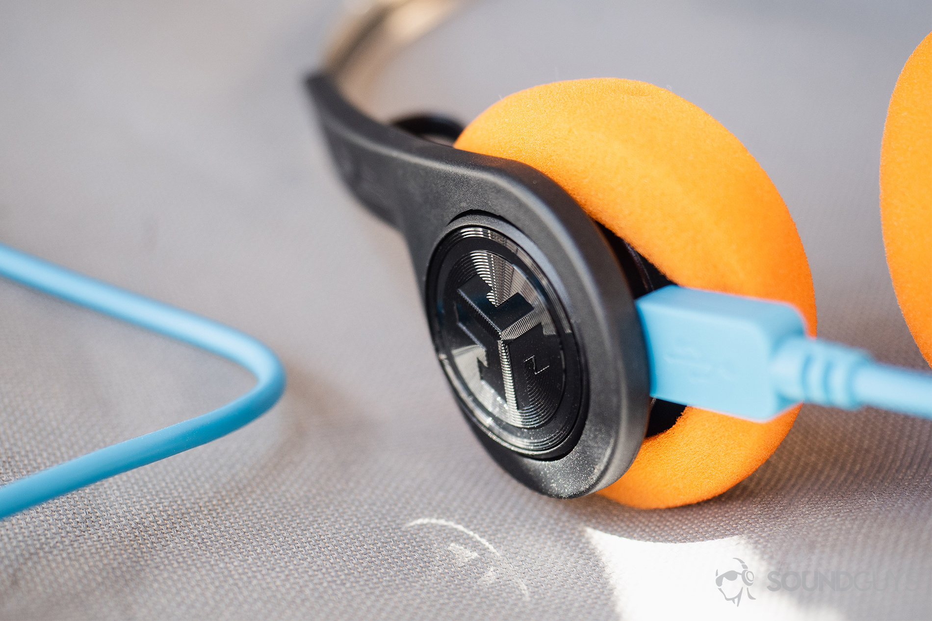 JLab_Audio Rewind Wireless Retro_LK_2 JLab Rewind Wireless Retro: The blue micro-USB is plugged into the headphones with oragne foam pads.