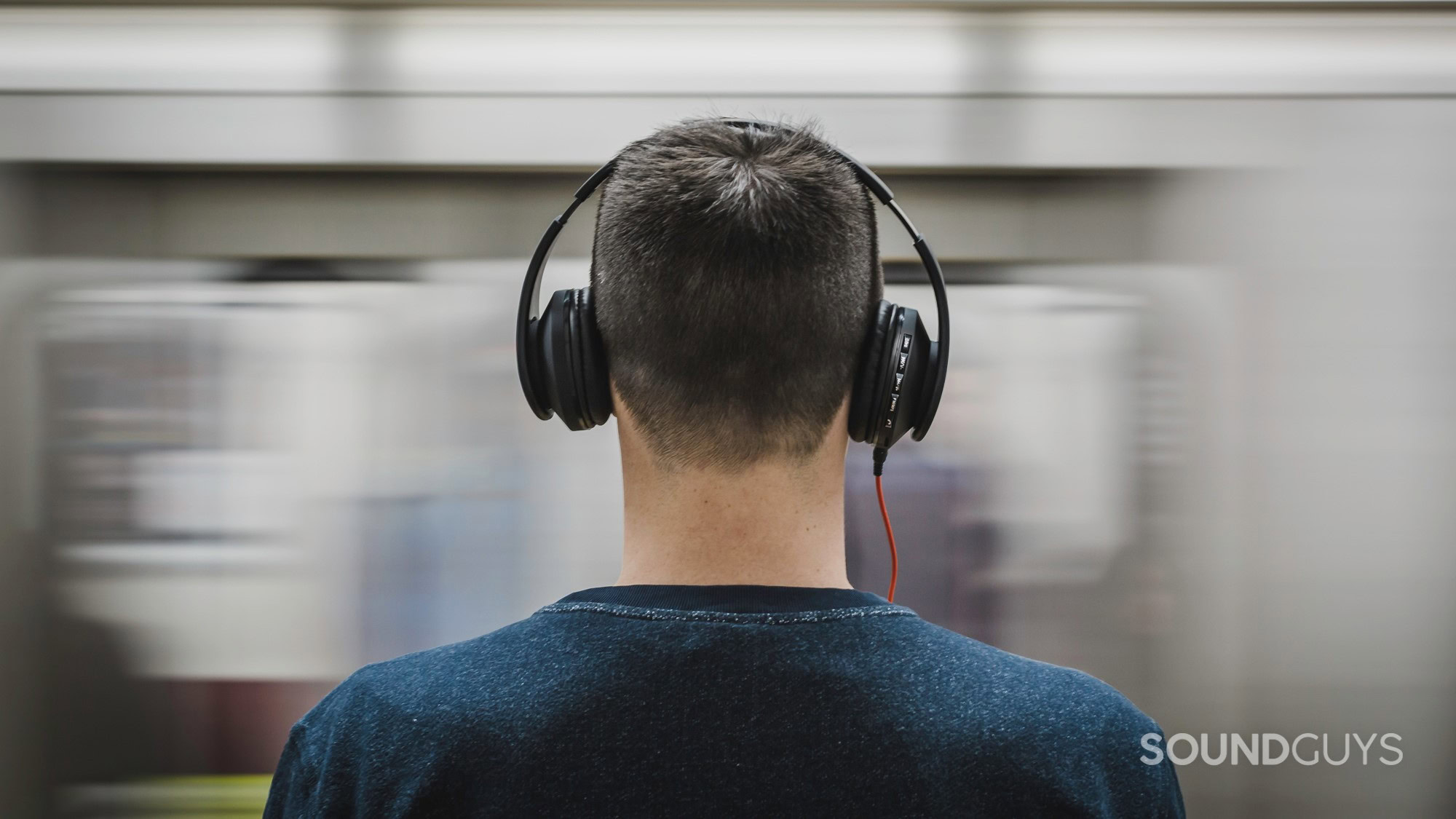 kids-headphones-subway A photo of a young man wearing headphones in front of a moving train