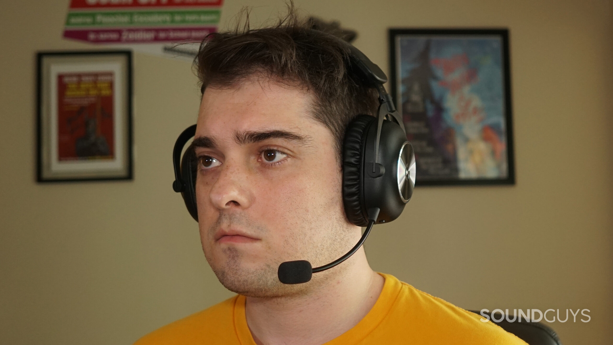 Logitech-G-Pro-X2-Lightspeed-headshot A man wears the Logitech G PRO X 2 LIGHTSPEED gaming headset while sitting at a computer.