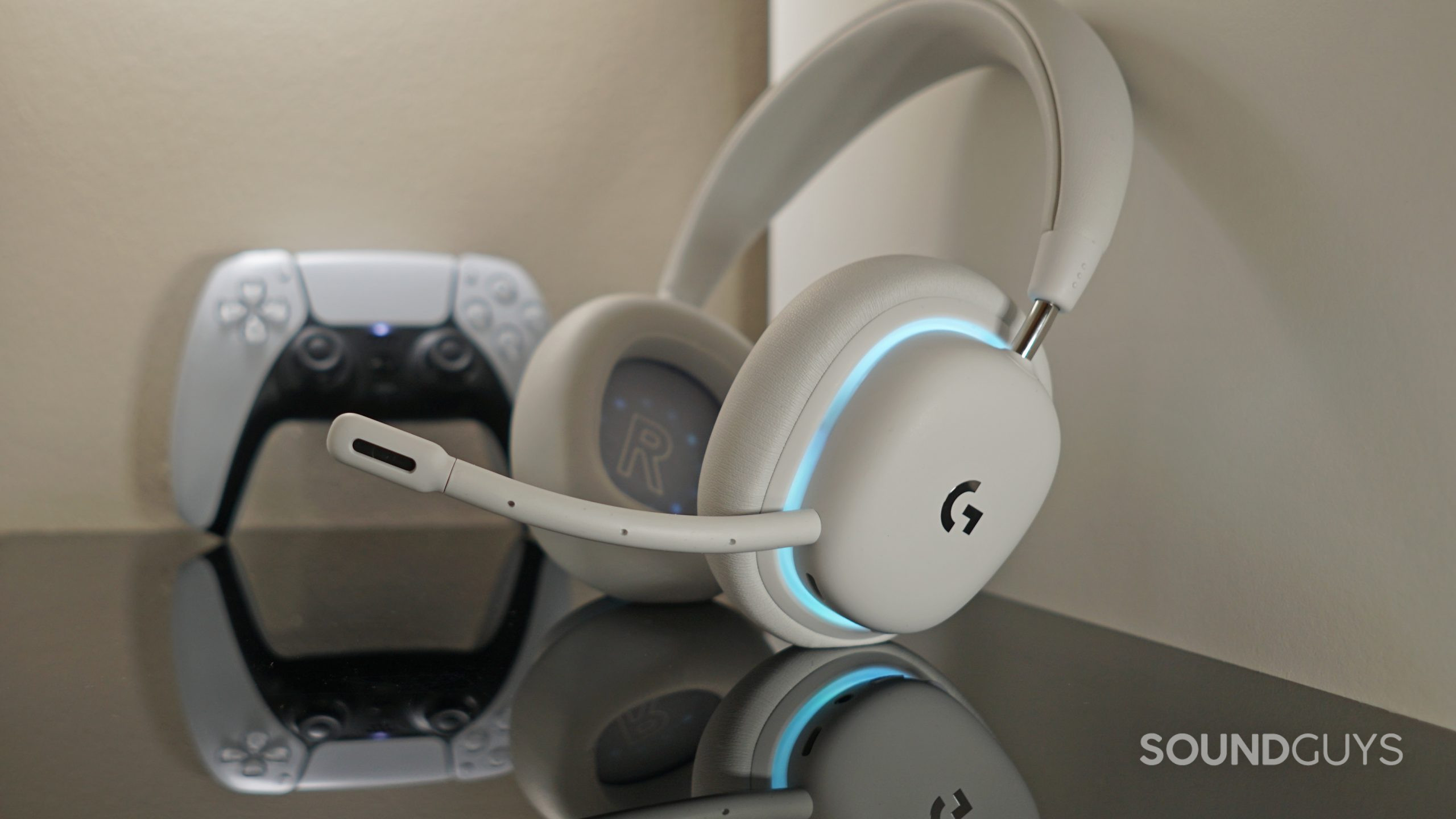 Logitech-G735-PS5-controller The Logitech G735 sits on a white shelf in front of a Sony DualSense controller.