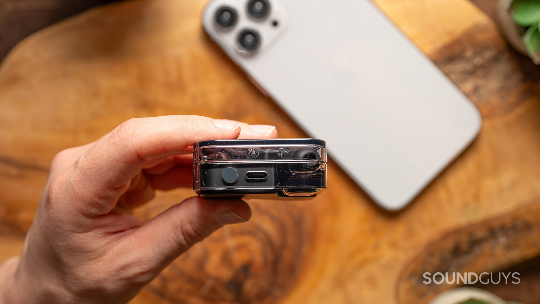 Nothing Ear port A hold holds the Nothing Ear charging case showing the USB-C port.