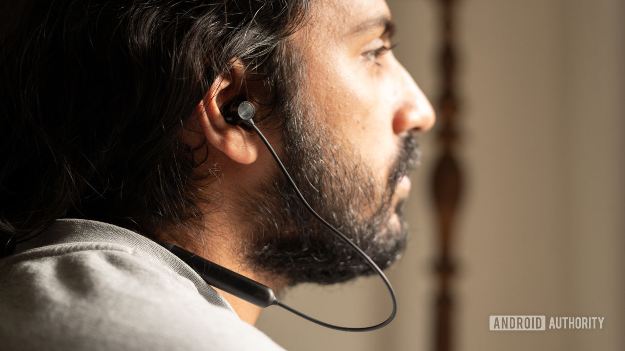 OnePlus-Bullets-Wireless-Z man wearing A picture of a man in profile wearing the OnePlus Bullets Wireless Z neckband earbuds.