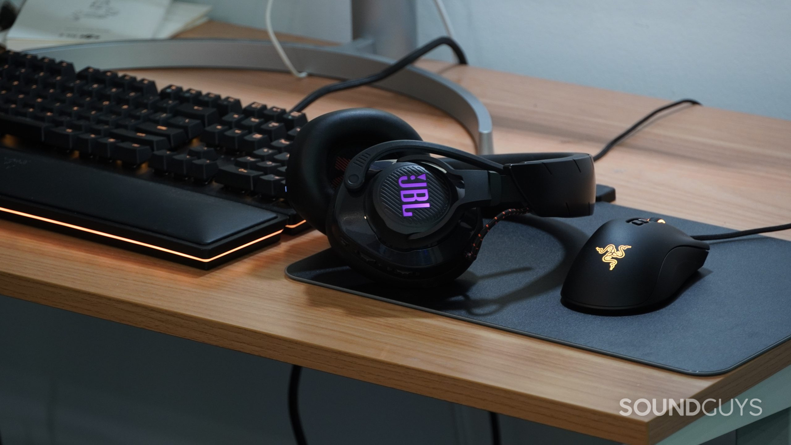 JBL Quantum 600 on a desk The JBL Quantum 600 on a desk next to some Razer peripherals