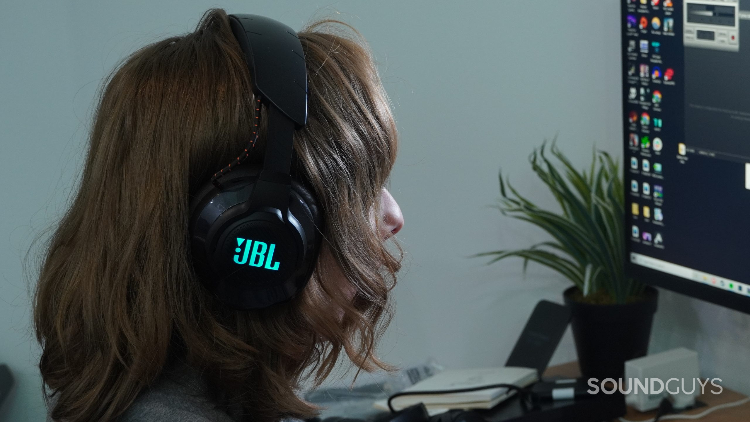 JBL Quantum 600 Worn A person wears the JBL Quantum 600 while gaming on a PC.