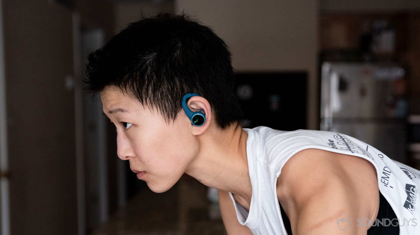 Plantronics BackBeat Fit 3200-woman wearing exercise athlete A picture of the Plantronics BackBeat Fit 3200 true wireless workout earbuds worn by a woman on a bike in profile.
