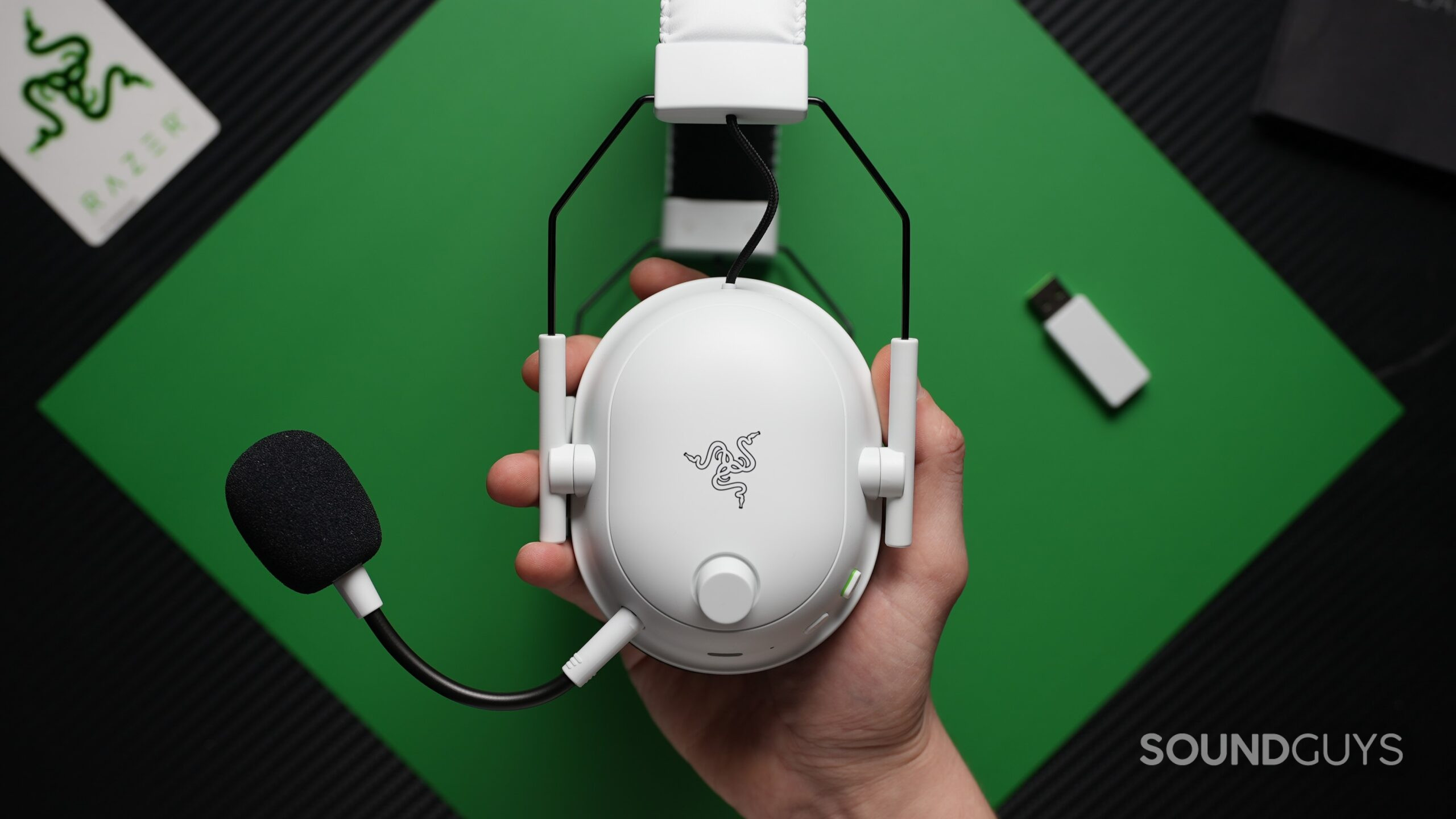 Razer BlackShark V2 Pro side a hand holding the Razer BlackShark V2 Pro 2023