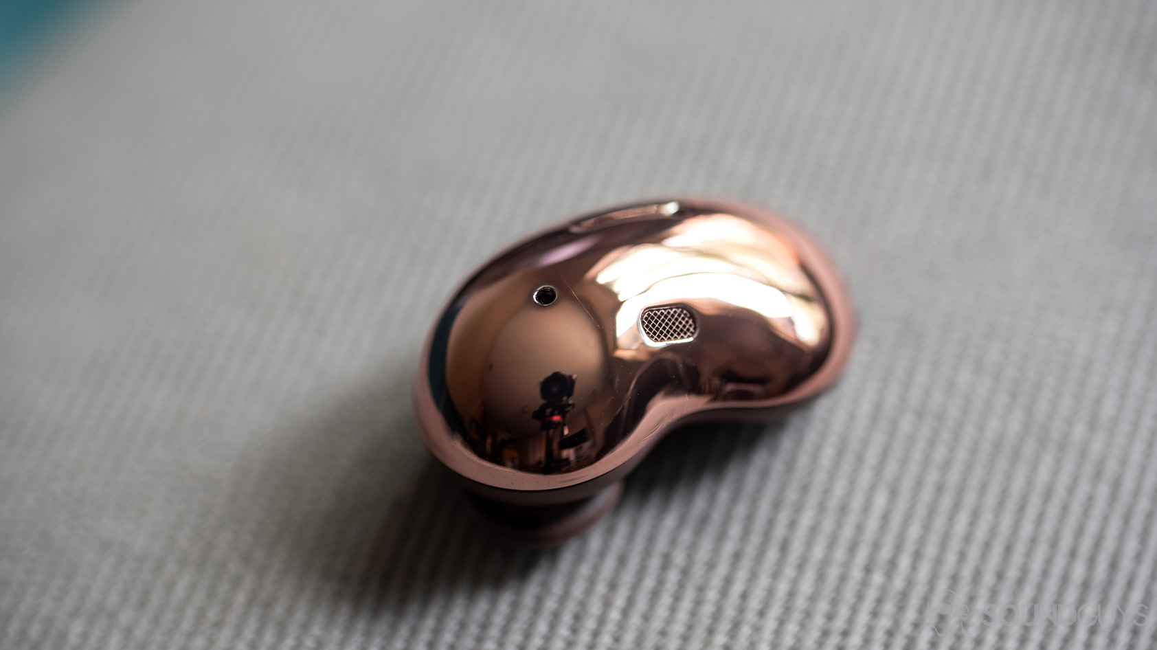 Samsung Galaxy Buds Live noise canceling true wireless earbuds bean shape A picture of the Samsung Galaxy Buds Live noise canceling true wireless earbuds bean shaped, reflective exterior; the earbud is at angle.