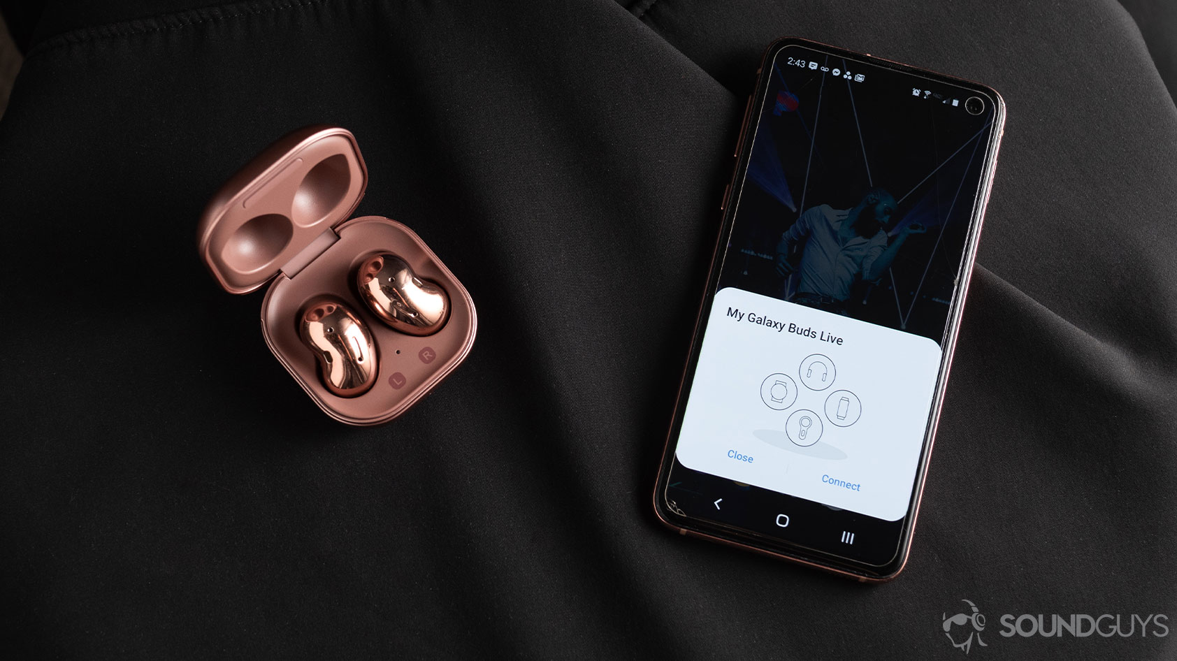 Samsung Galaxy Buds Live noise canceling true wireless earbuds case quick connect pairing A picture of the Samsung Galaxy Buds Live noise canceling true wireless earbuds in the open case next to a Samsung Galaxy S10e smartphone with quick pairing.