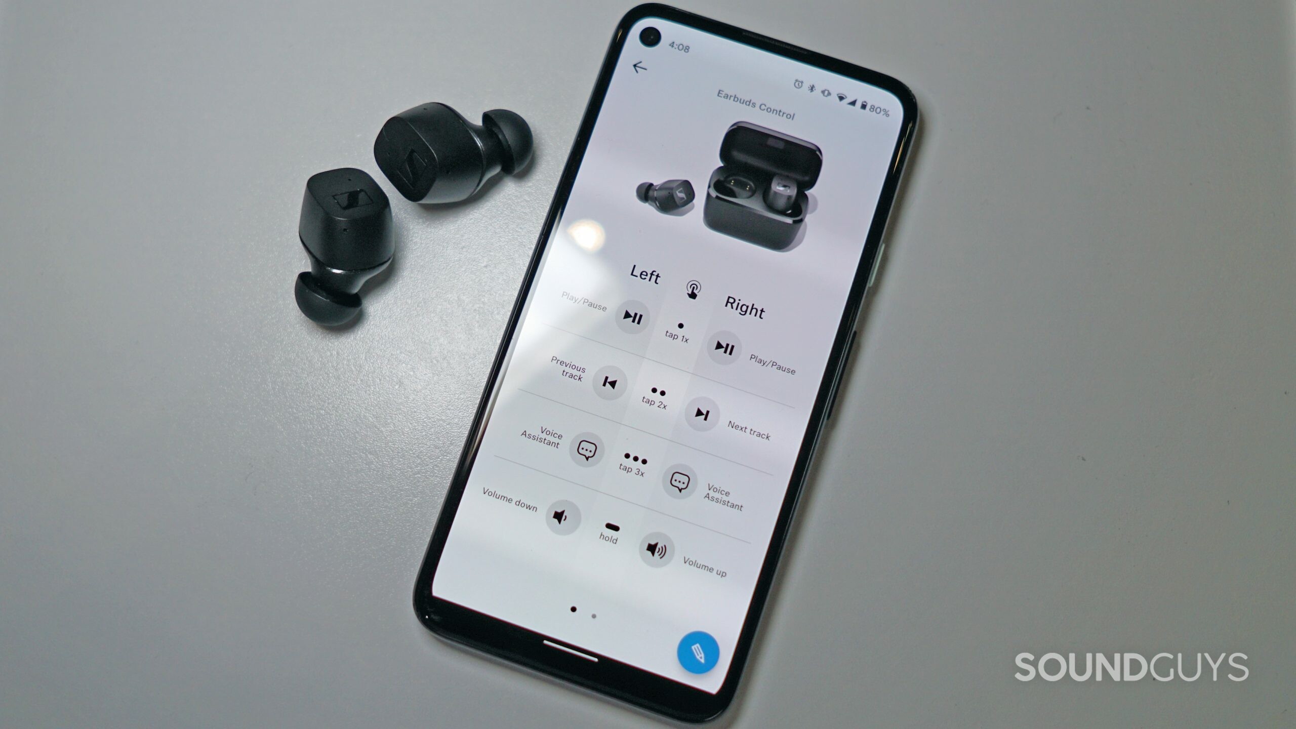 Sennheiser-CX-TWS-app-shot The Sennheiser CX TWS lies on a white surface next to a Google Pixel 4a running the Sennheiser Smart Control app to show how to EQ Bluetooth headphones.