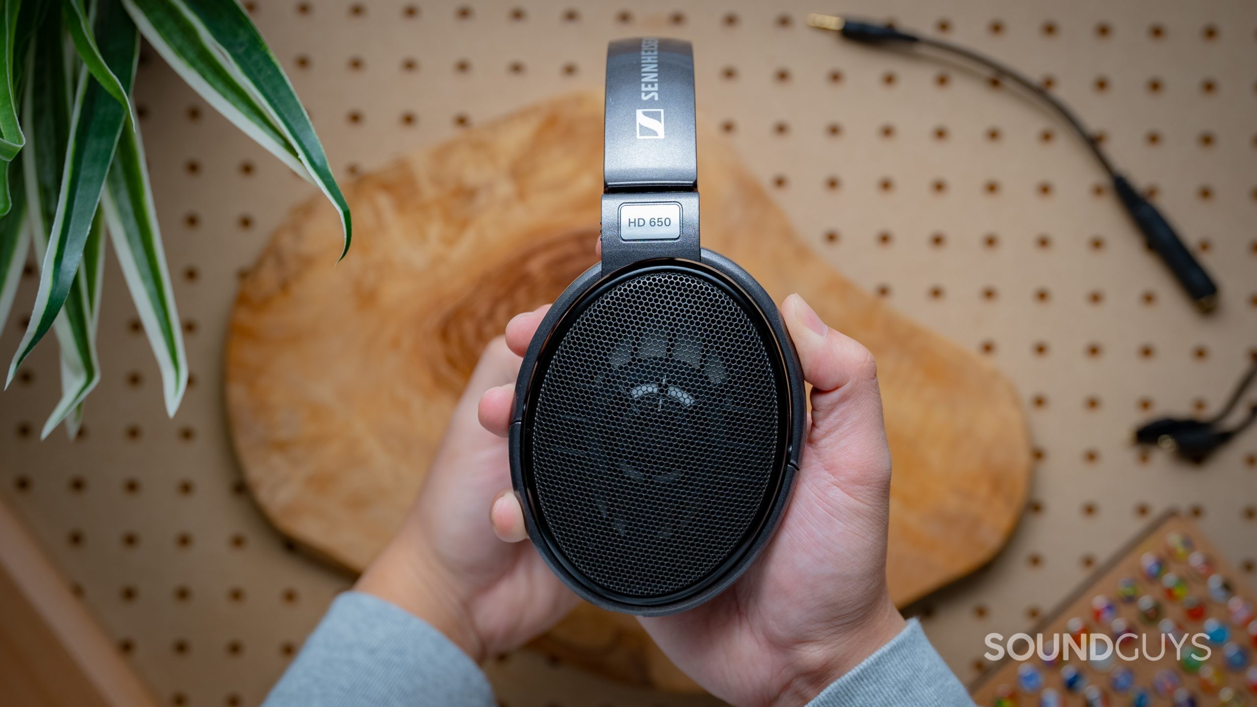 Sennheiser HD650 Featured Image #1 Sennheiser HD650 held in hand, viewed sideways on, no cable connected.
