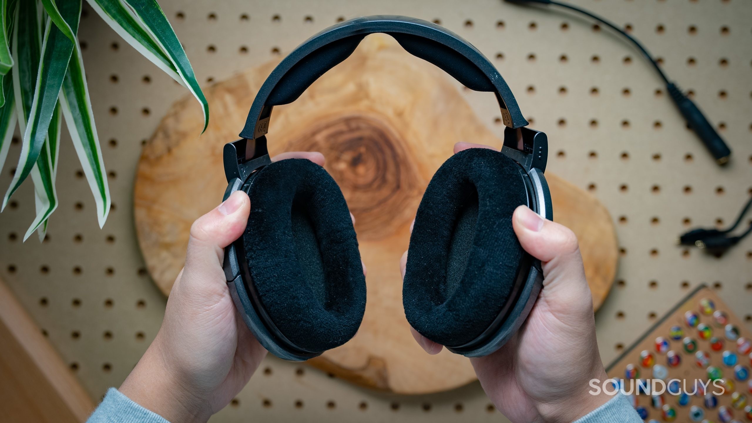 Sennheiser HD650 Featured Image #2 Sennheiser HD650 held in hand, viewed sideways on, no cable connected.