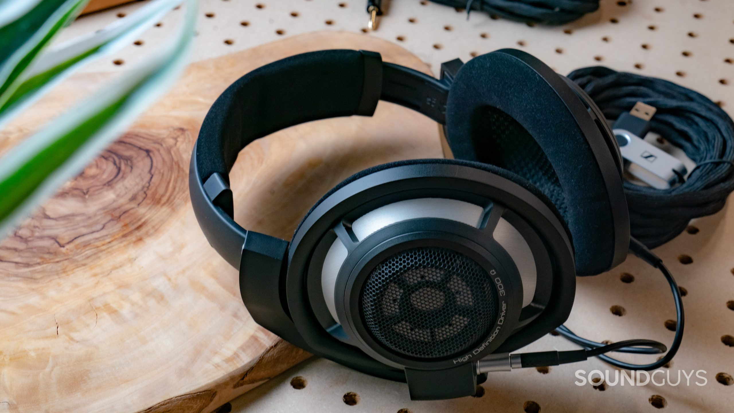 Sennheiser HD800 Hero Image #1 A photo of the Sennheiser HD 800 S lying atop a wood slab and pegboard.
