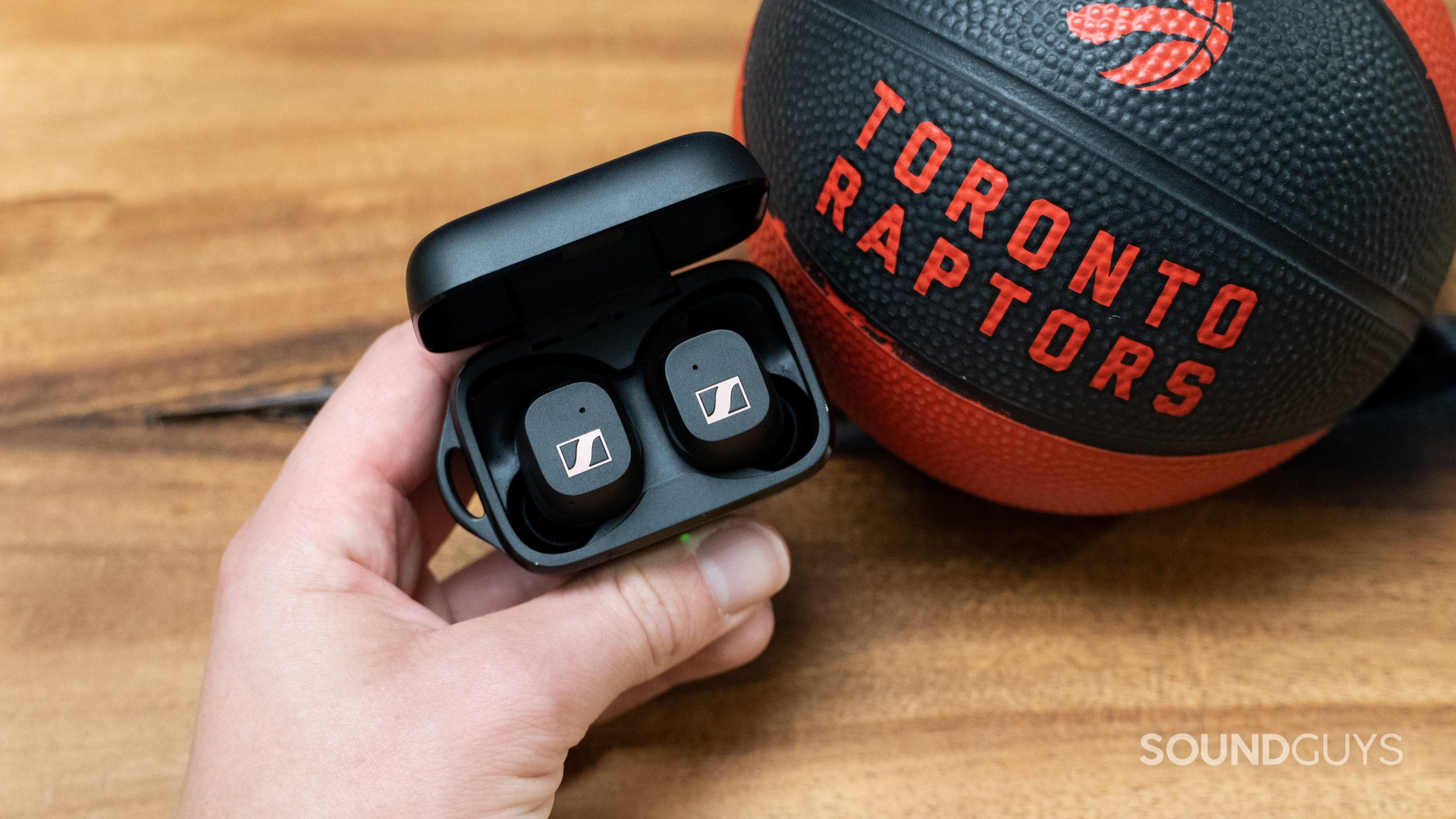 Sennheiser Sport True Wireless Earbuds next to basketball Sennheiser Sport True Wireless earbuds next to a basketball